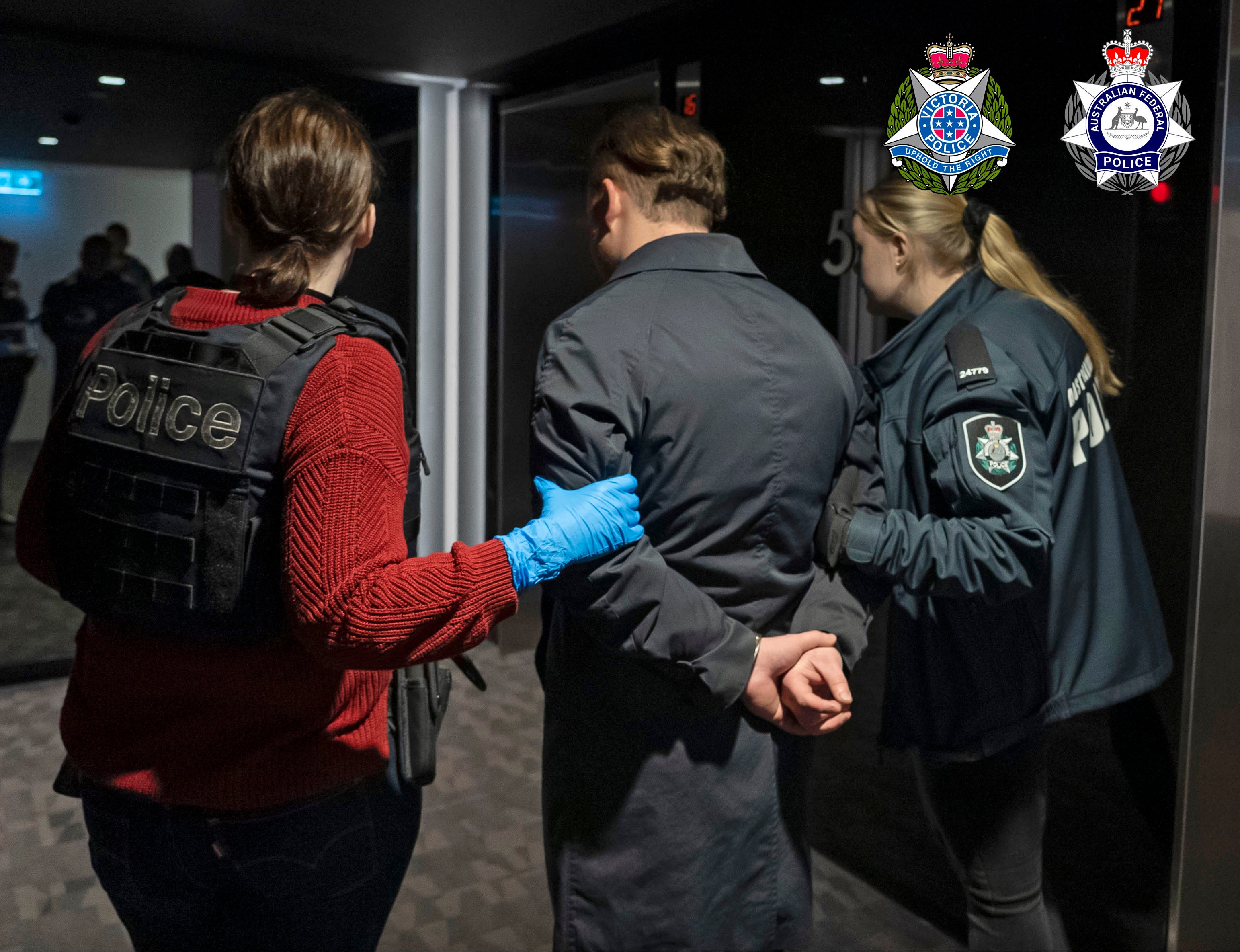 In this photo provided by the Australian Federal Police a man is taken into custody in Melbourne, Wednesday, 14 June 2023. A drug syndicate that tried to smuggle tons of methamphetamine from Canada to Australia and New Zealand by hiding it in shipments of maple syrup and canola oil has been busted, authorities said Thursday, 15 June 2023