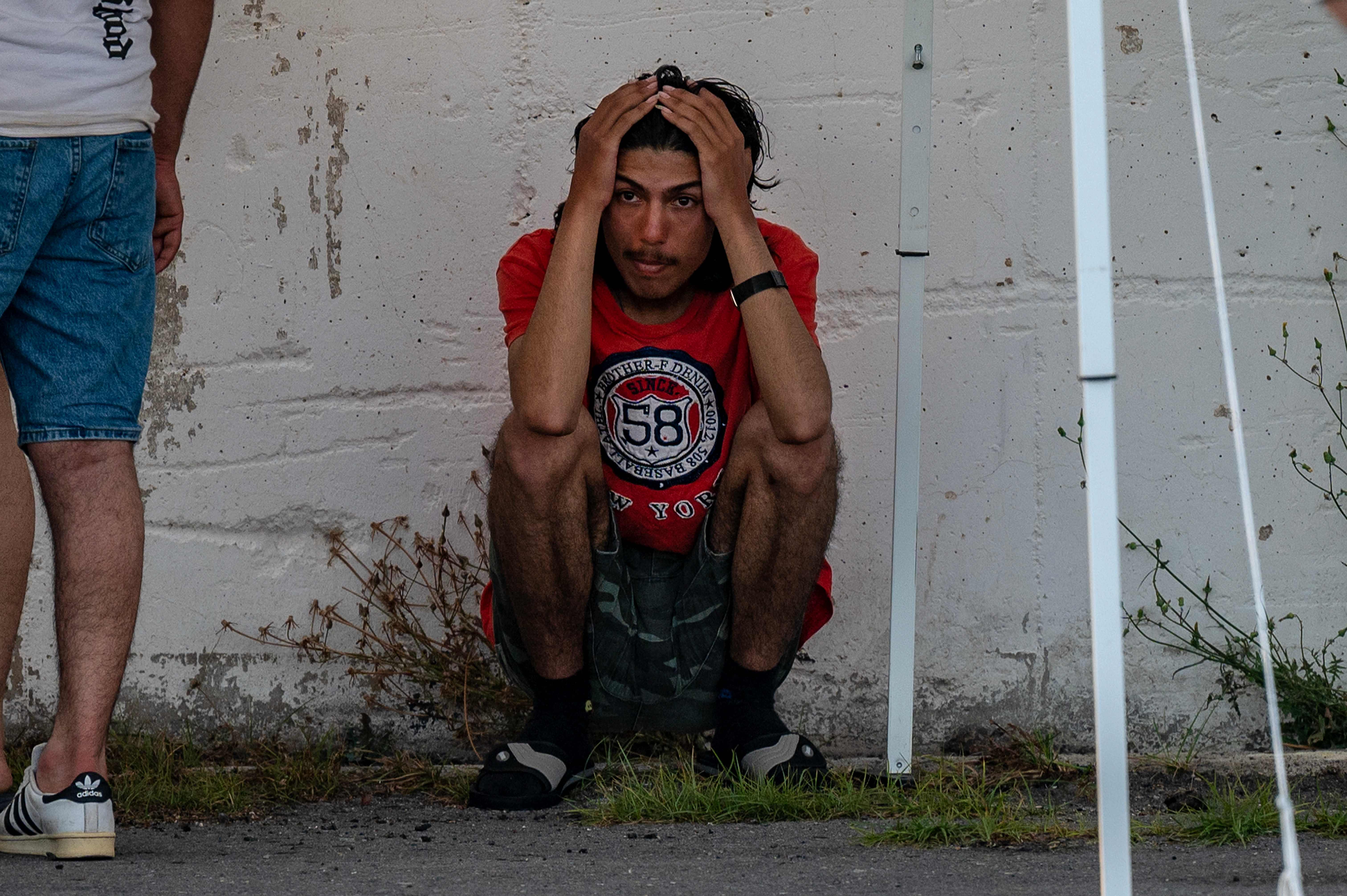 A survivor of a shipwreck stands outside a warehouse at the port in Kalamata town on 14 June