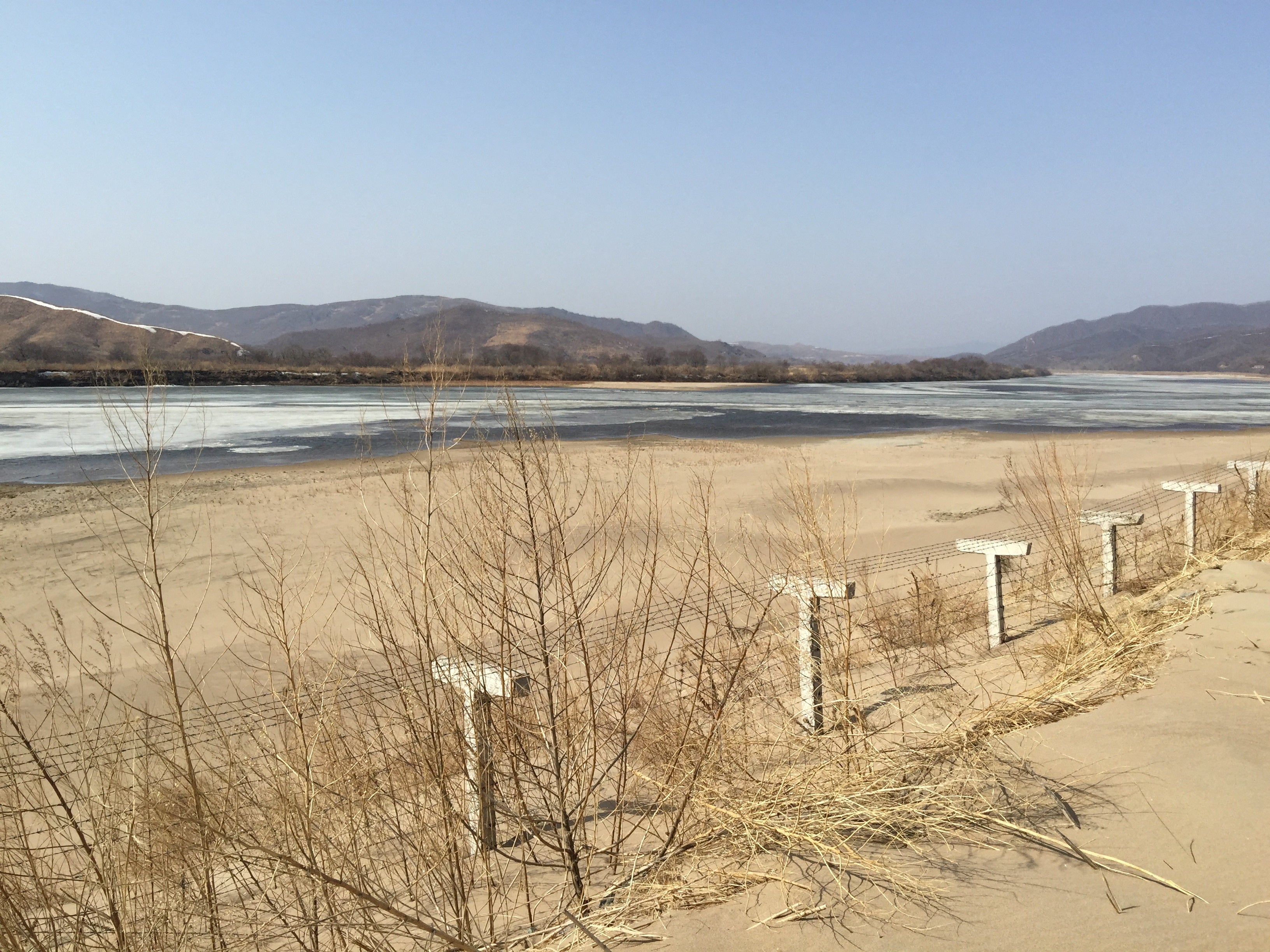 A barbed-wire fence separating North Korea from China is seen in this photo taken from the Chinese border city of Hunchun