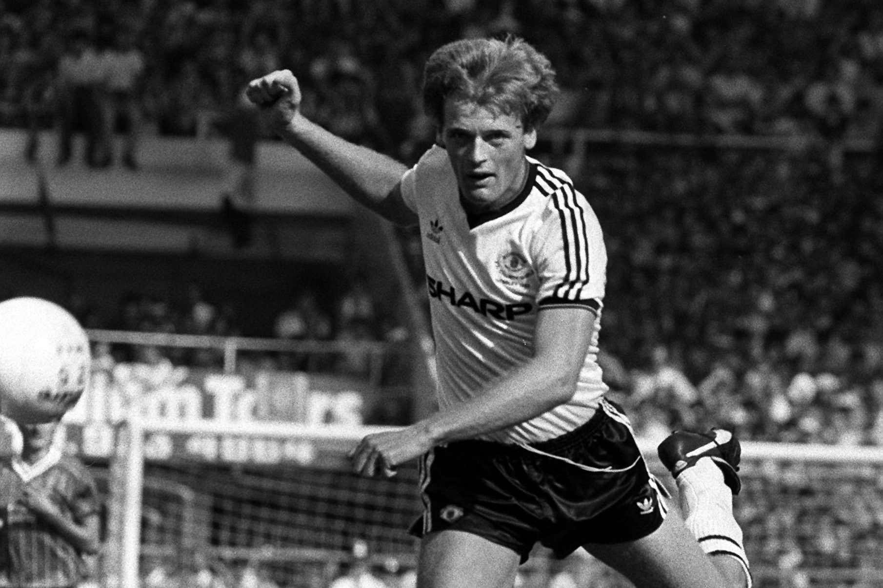 Gordon McQueen in action for Manchester United (PA)