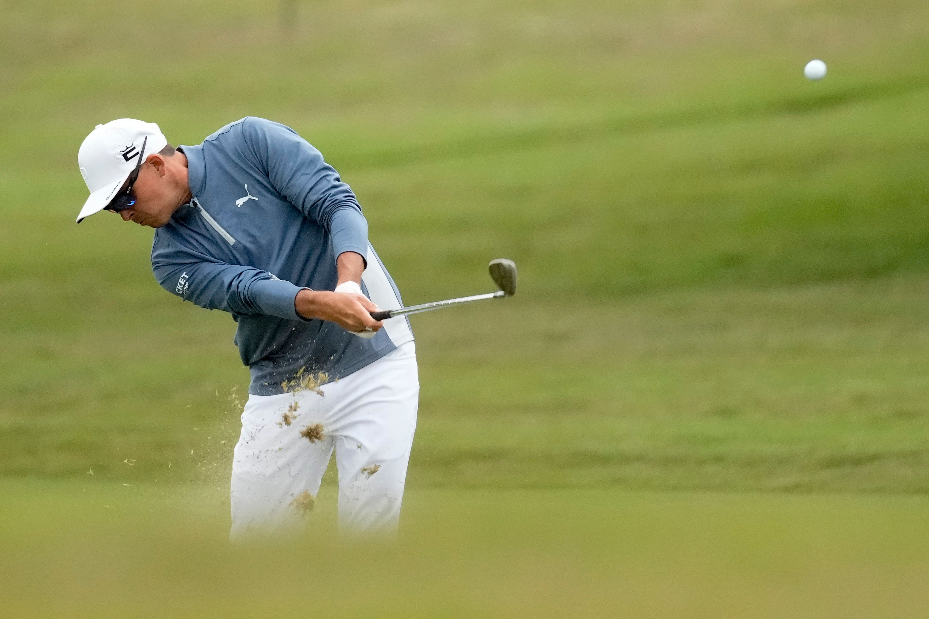 Rickie Fowler hits from the fairway on the 10th hole during the first round of the US Open (Marcio J. Sanchez/AP)