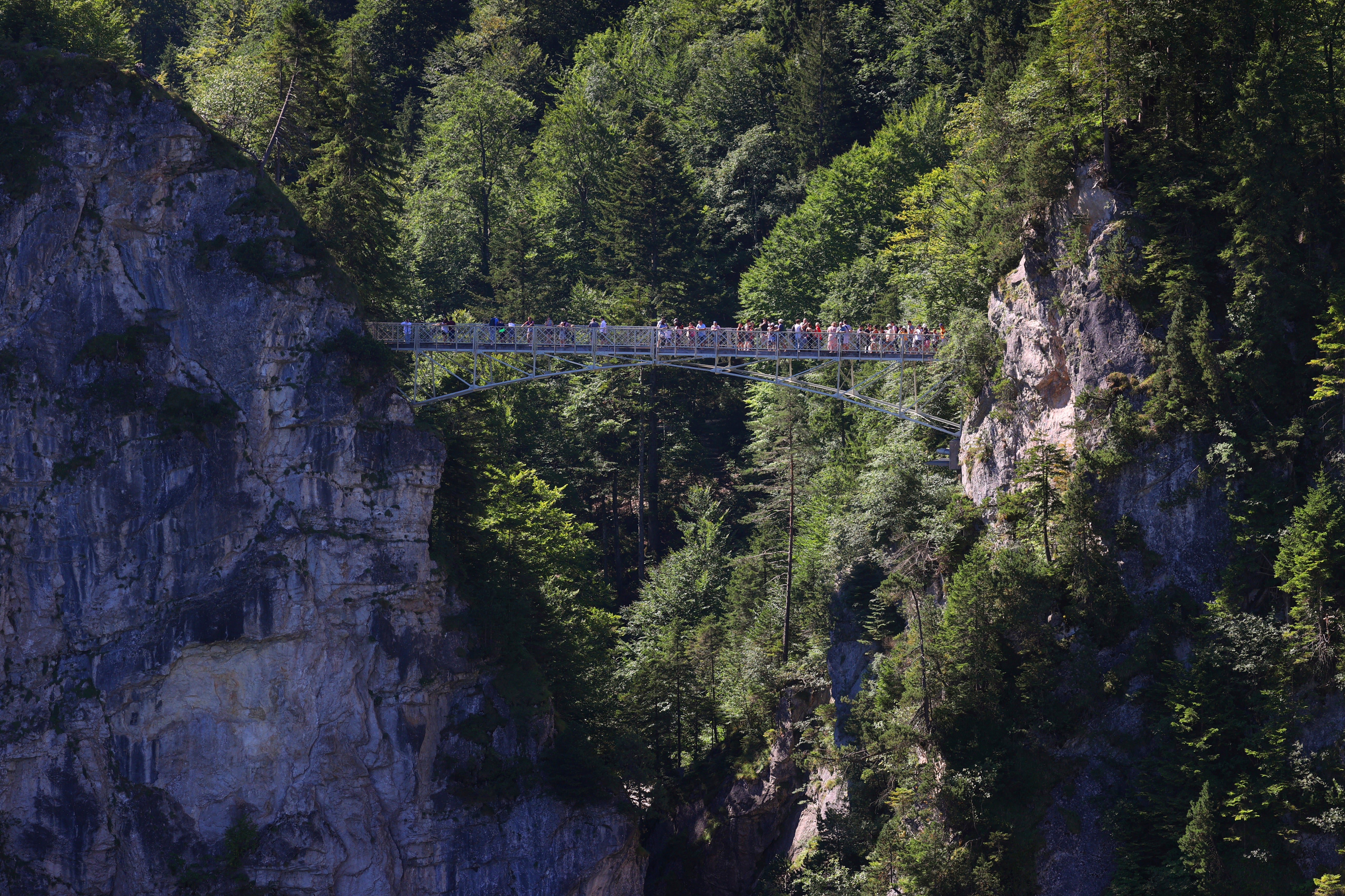 Tourists stand on the Marienbr'cke bridge, near the Neuschwanstein castle, in Schwangau, Germany