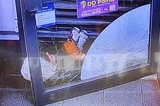 Watch: Quick-thinking shopkeeper foils robbery by trapping intruder under shutters