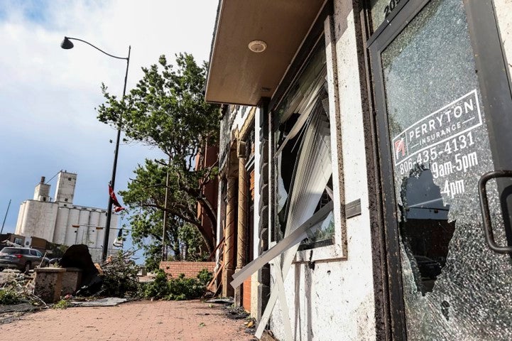 Stores in downtown Perryton, Texas, show damage after a tornado passed through the region on Thursday