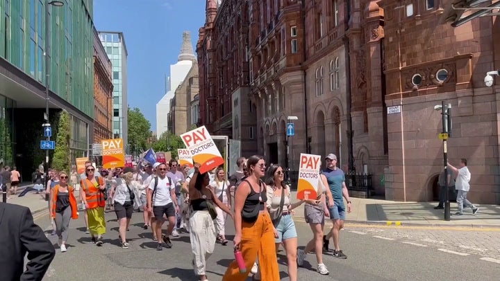 Striking junior doctors march through Manchester in row with government over pay