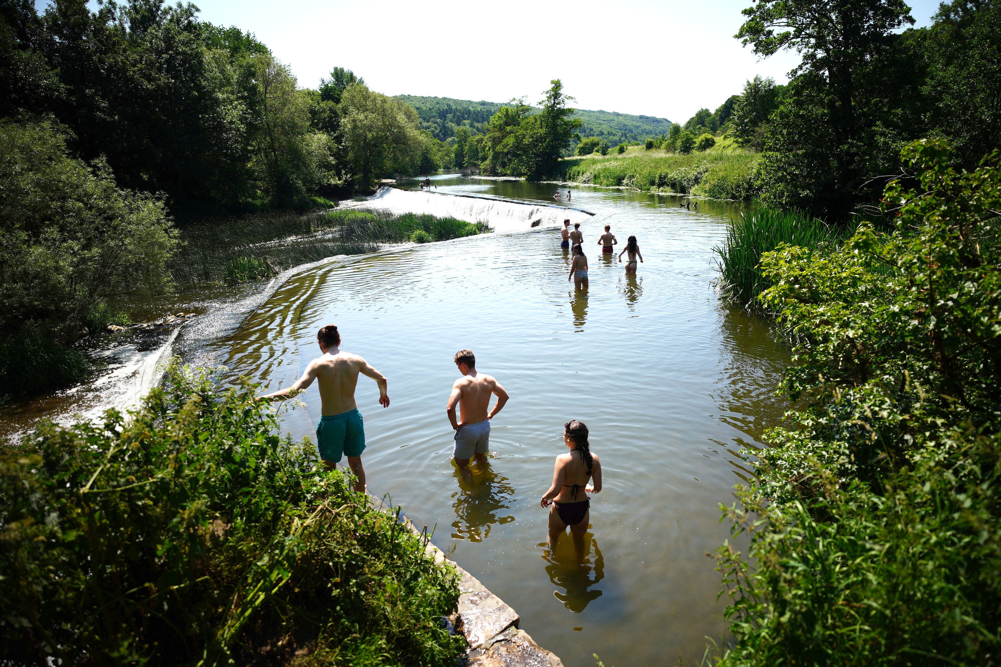 People in the water at Warleigh Weir near Bath on June 14 as temperatures soared