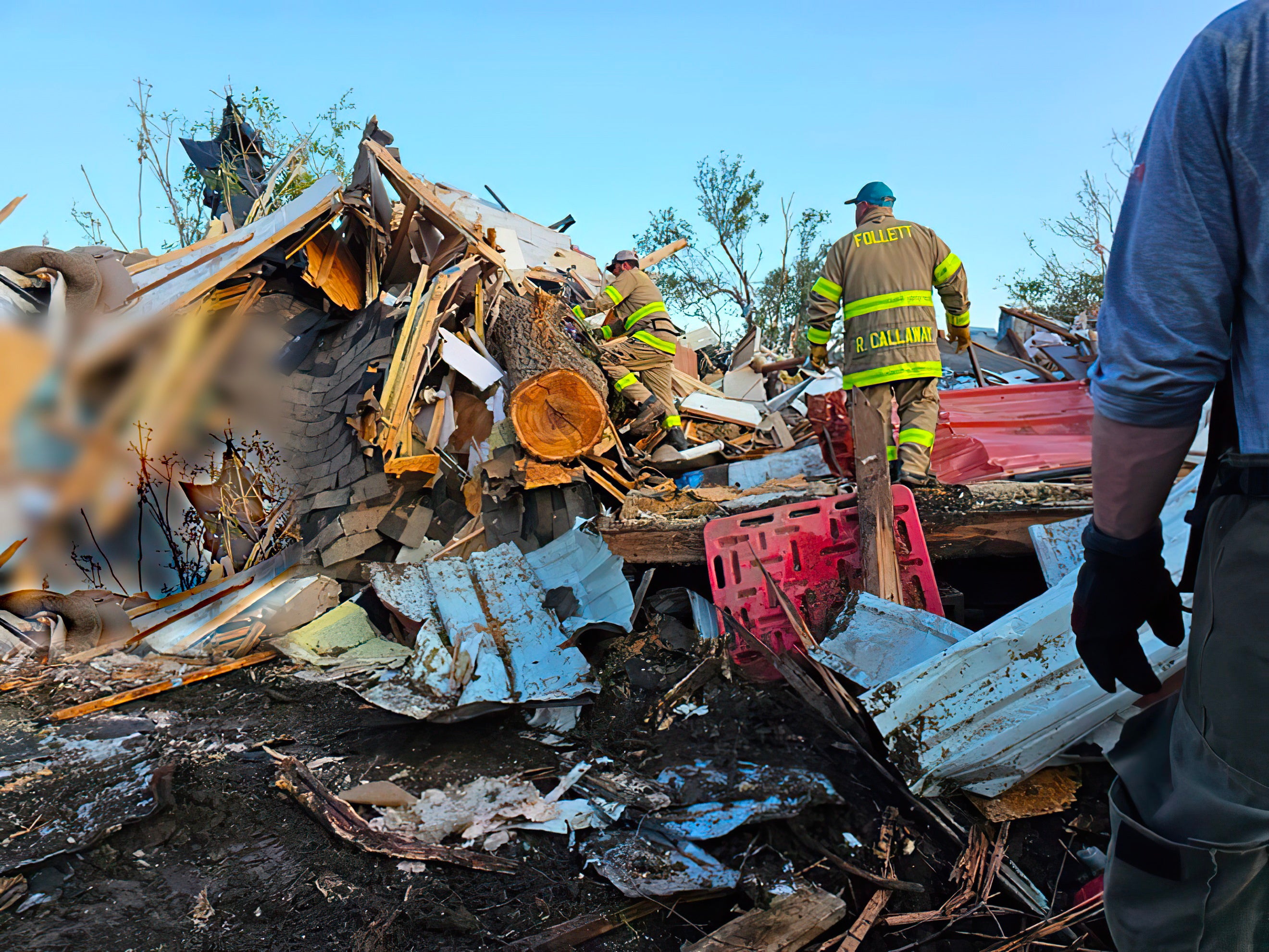 Firefighters search the collapsed buildings following the tornado in Perryton, Texas