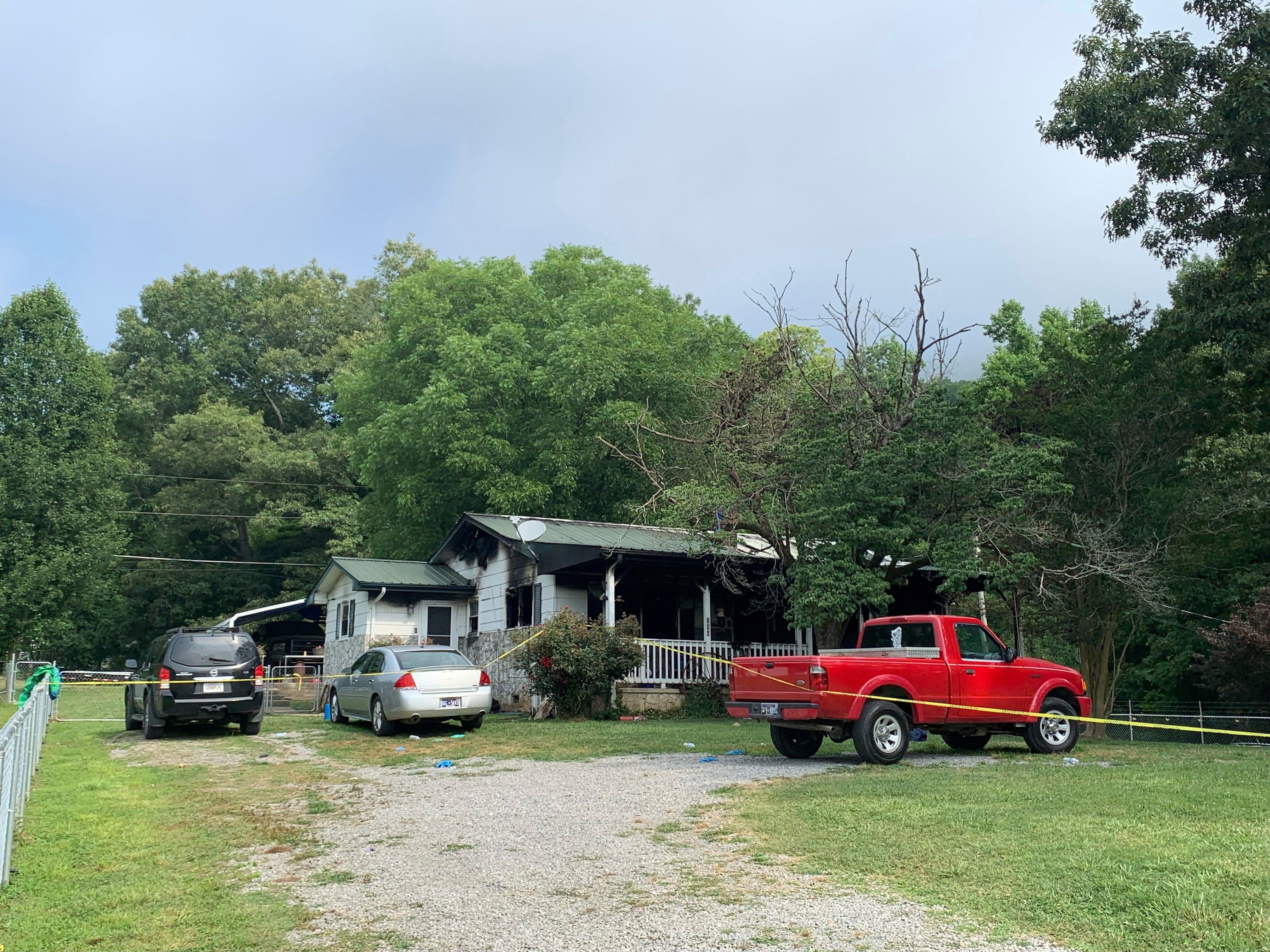 Police tape blocks off a home in Sequatchie, Tennessee, where six people including three children were found dead