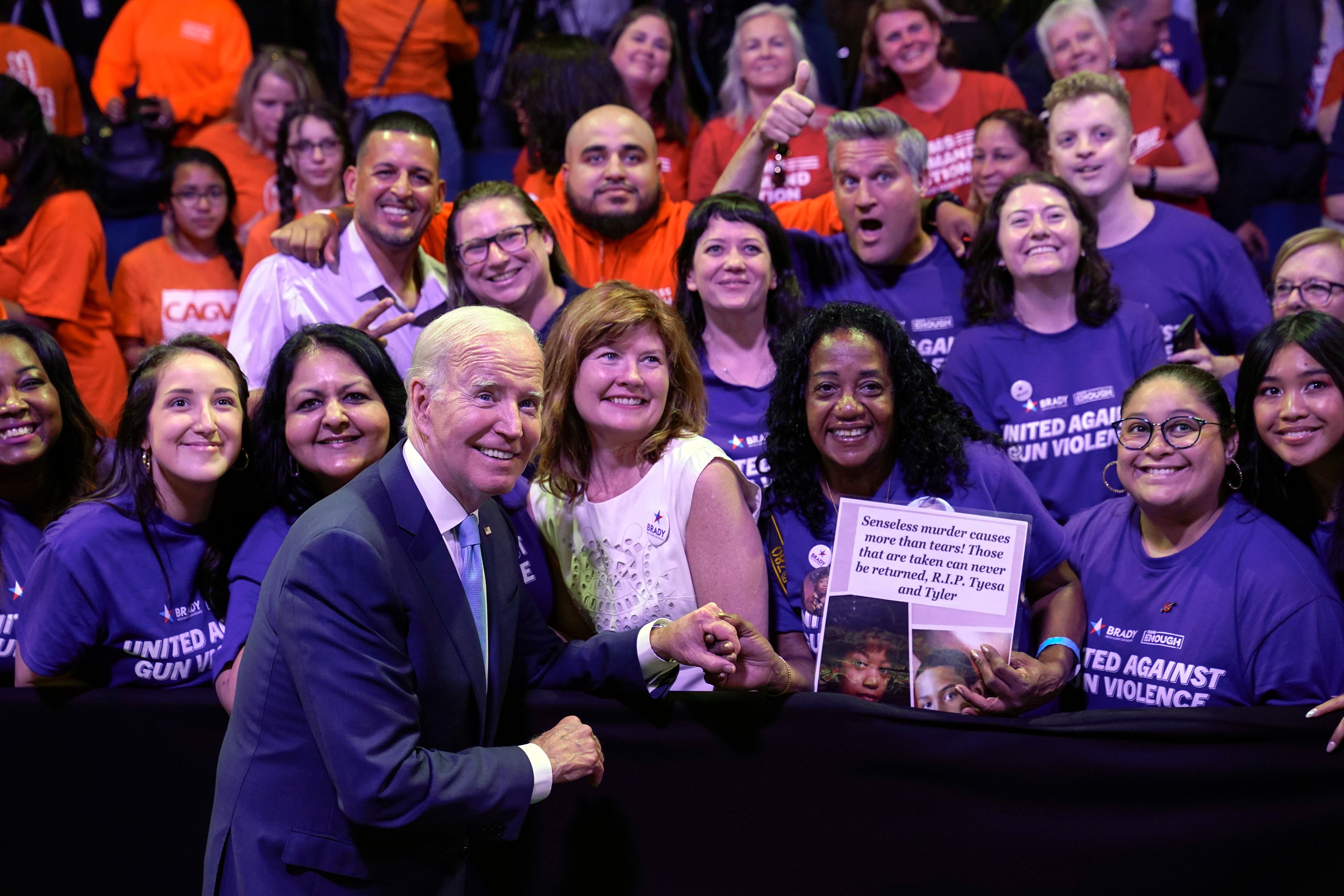 President Joe Biden poses for a photo with people in the audience after speaking at the National Safer Communities Summit at the University of Hartford in West Hartford, Conn., Friday, June 16, 2023.