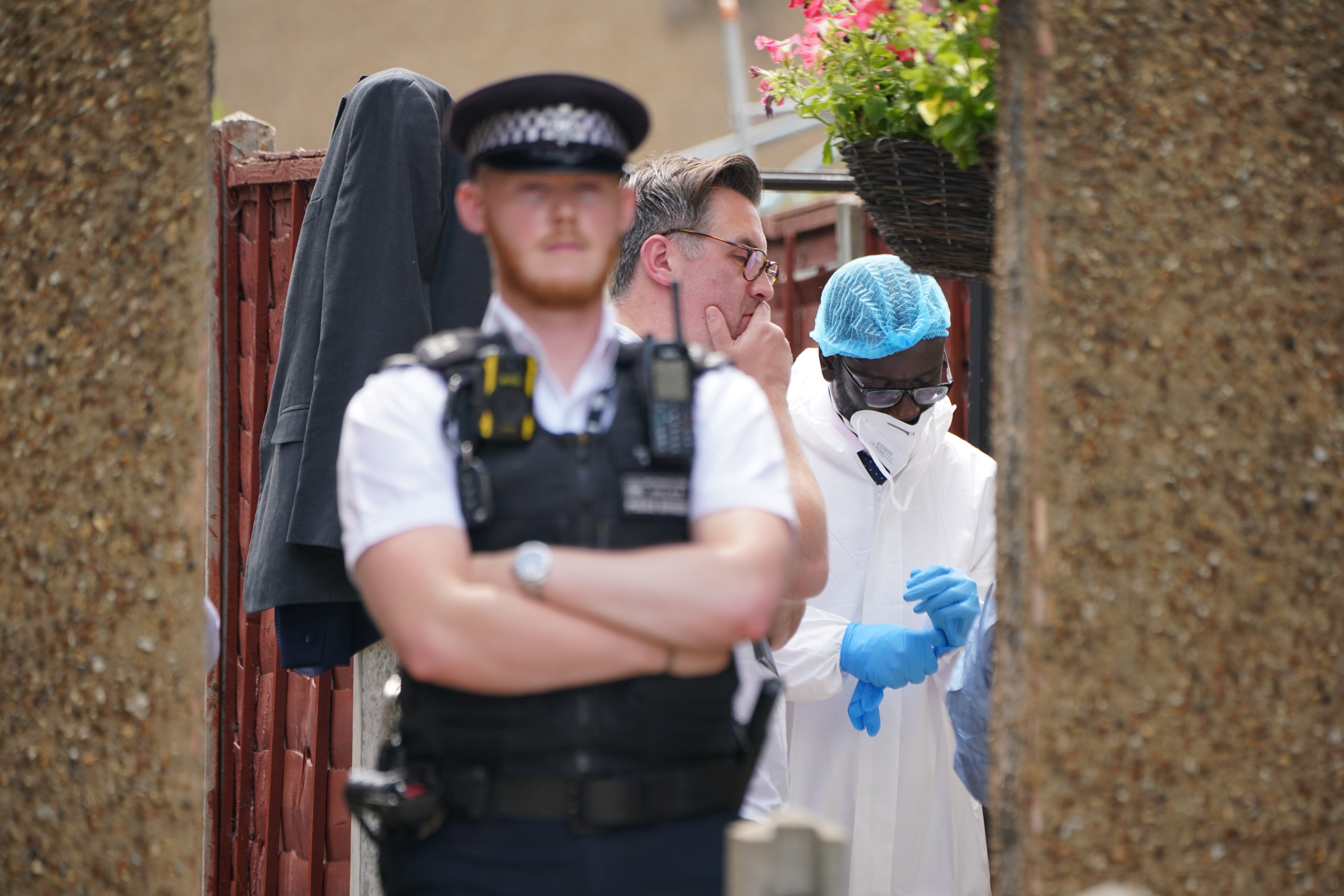 Police and forensic investigators at the scene in Bedfont, Hounslow