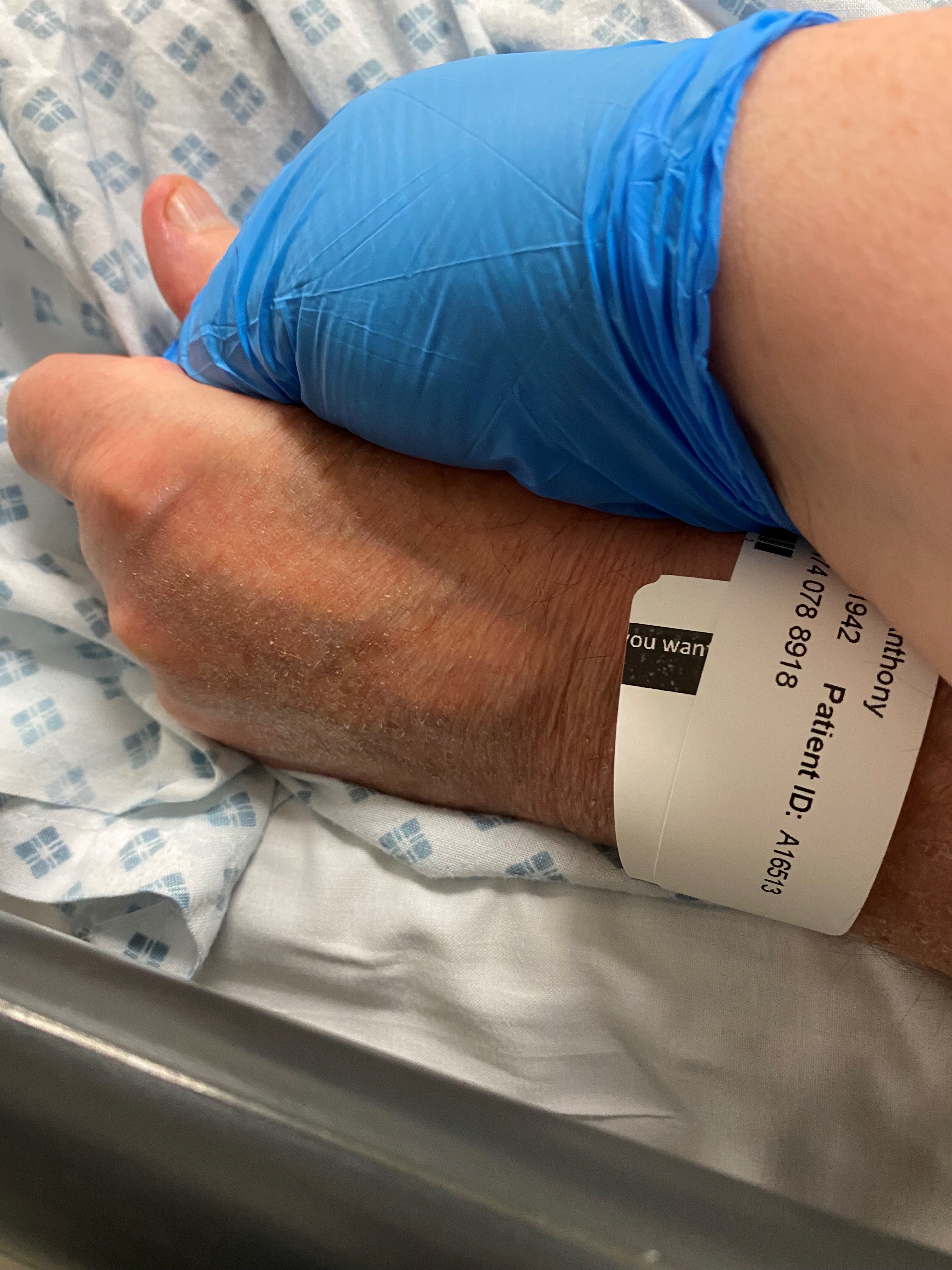 Ms Carney holds her father’s hand in hospital the last time she ever saw him