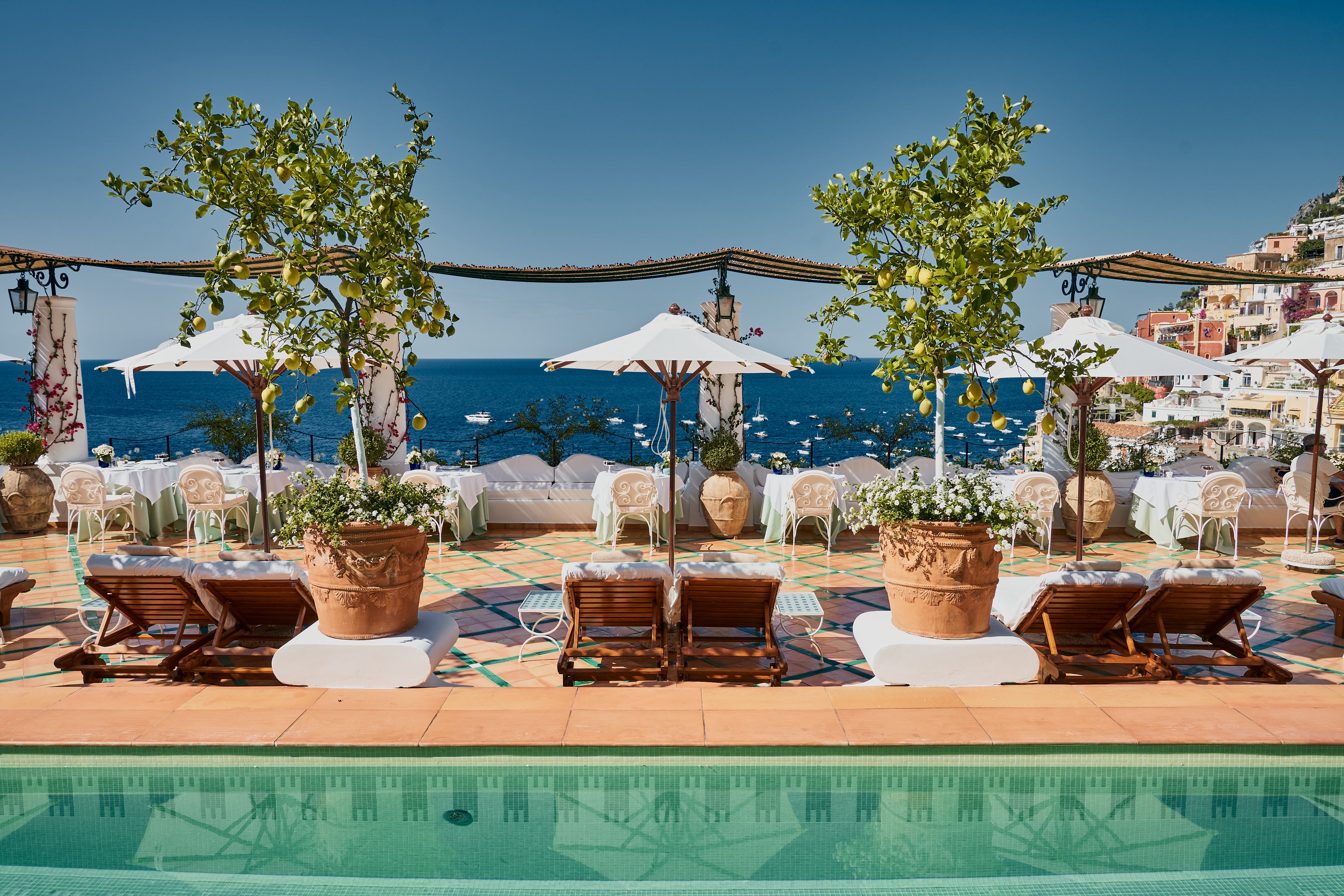 Guests can lounge poolside by the potted lemon trees while taking in the incredible views