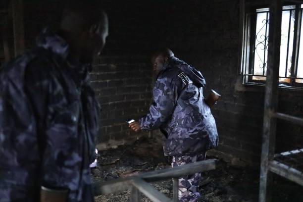 Uganda security forces are seen at the premises of an attack in Mpondwe, Uganda, on 18 June 2023 at the Mpondwe Lhubiriha Secondary School