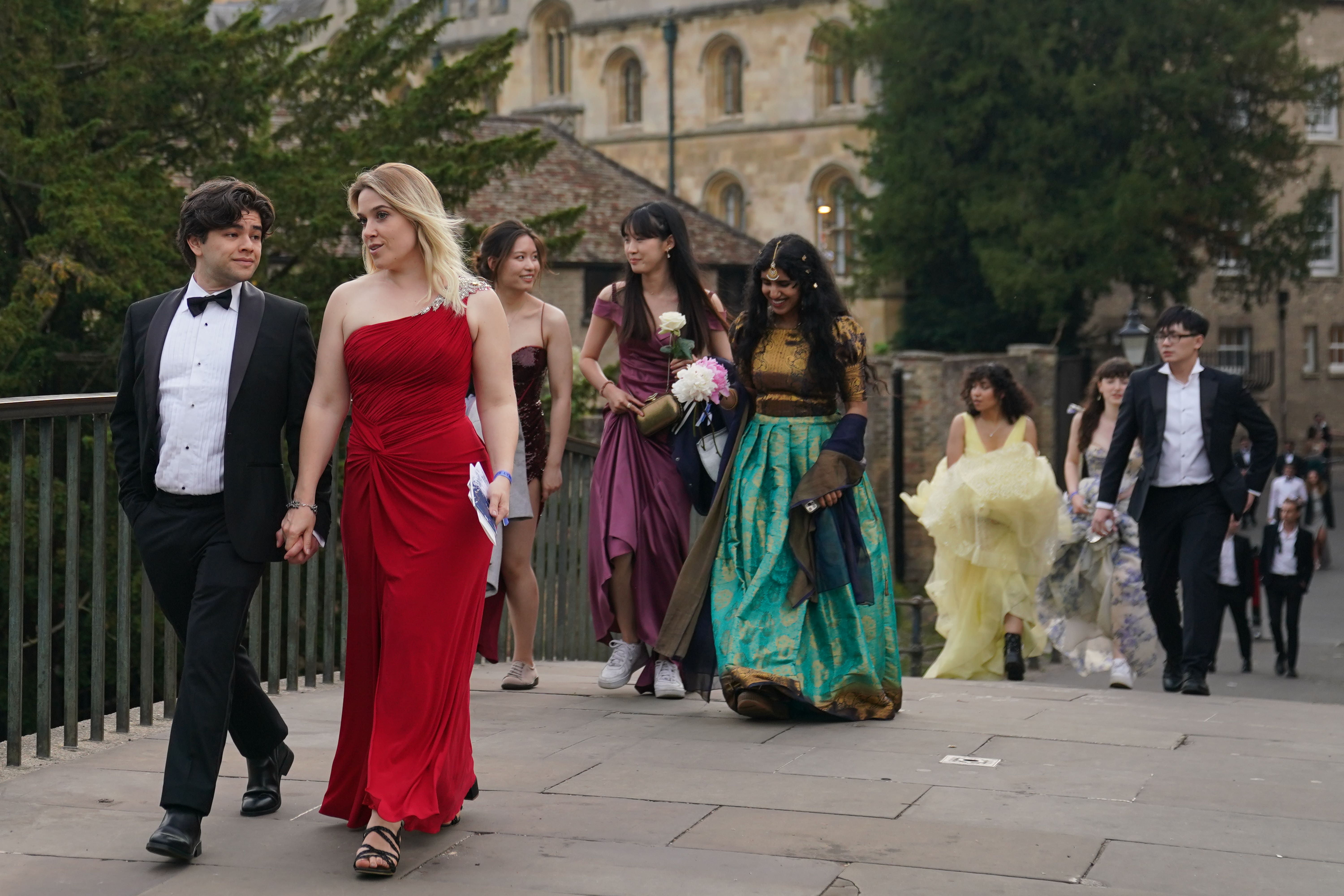 Students from Cambridge University make their way home after celebrating the end of the academic year (Joe Giddens/ PA)