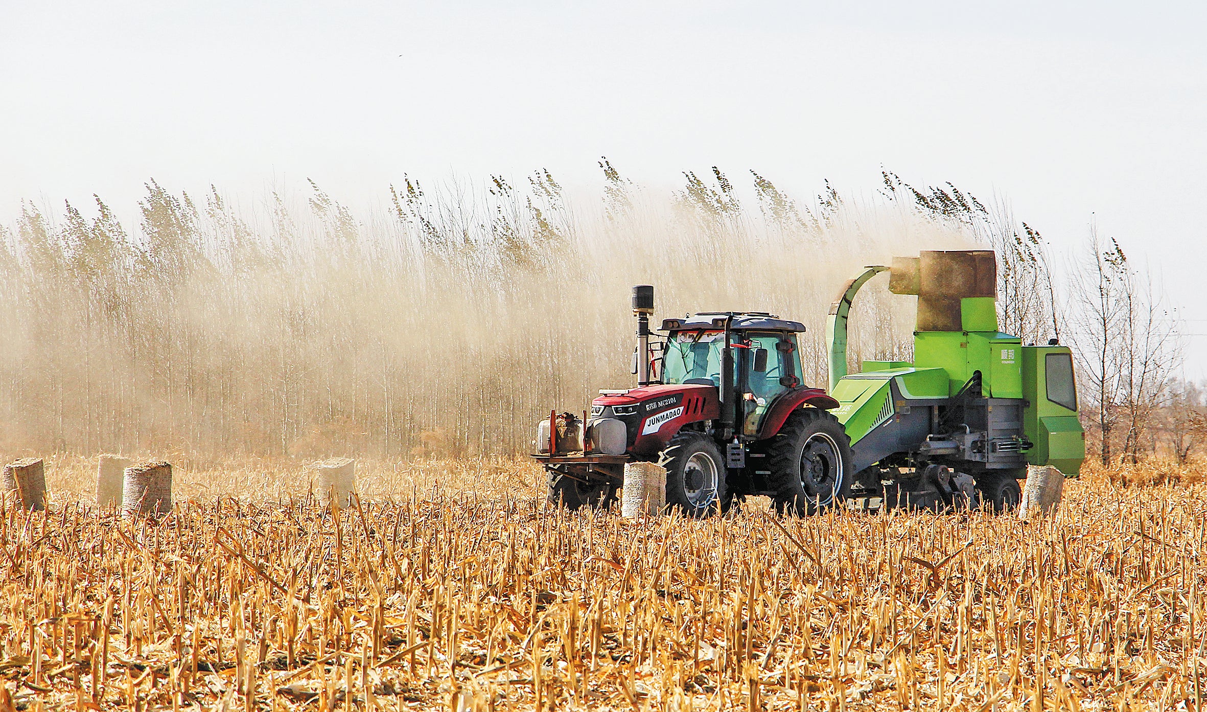 A farmer uses agricultural machinery to compress straw stalks into blocks that will be used as winter fodder for farm animals in Tongliao, Inner Mongolia autonomous region, on November 4, 2022