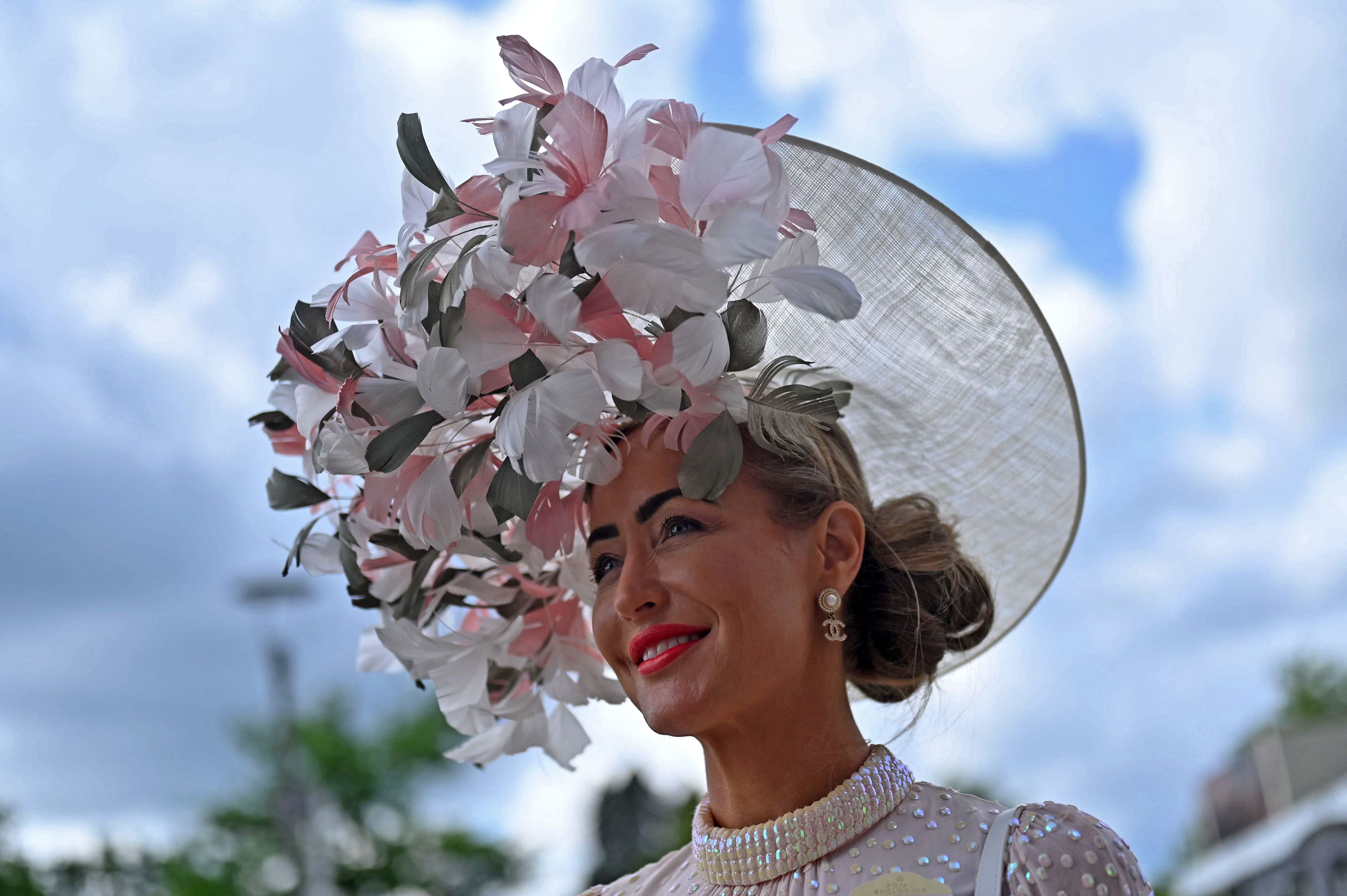 A racegoer poses for a photograph on the second day of the Royal Ascot