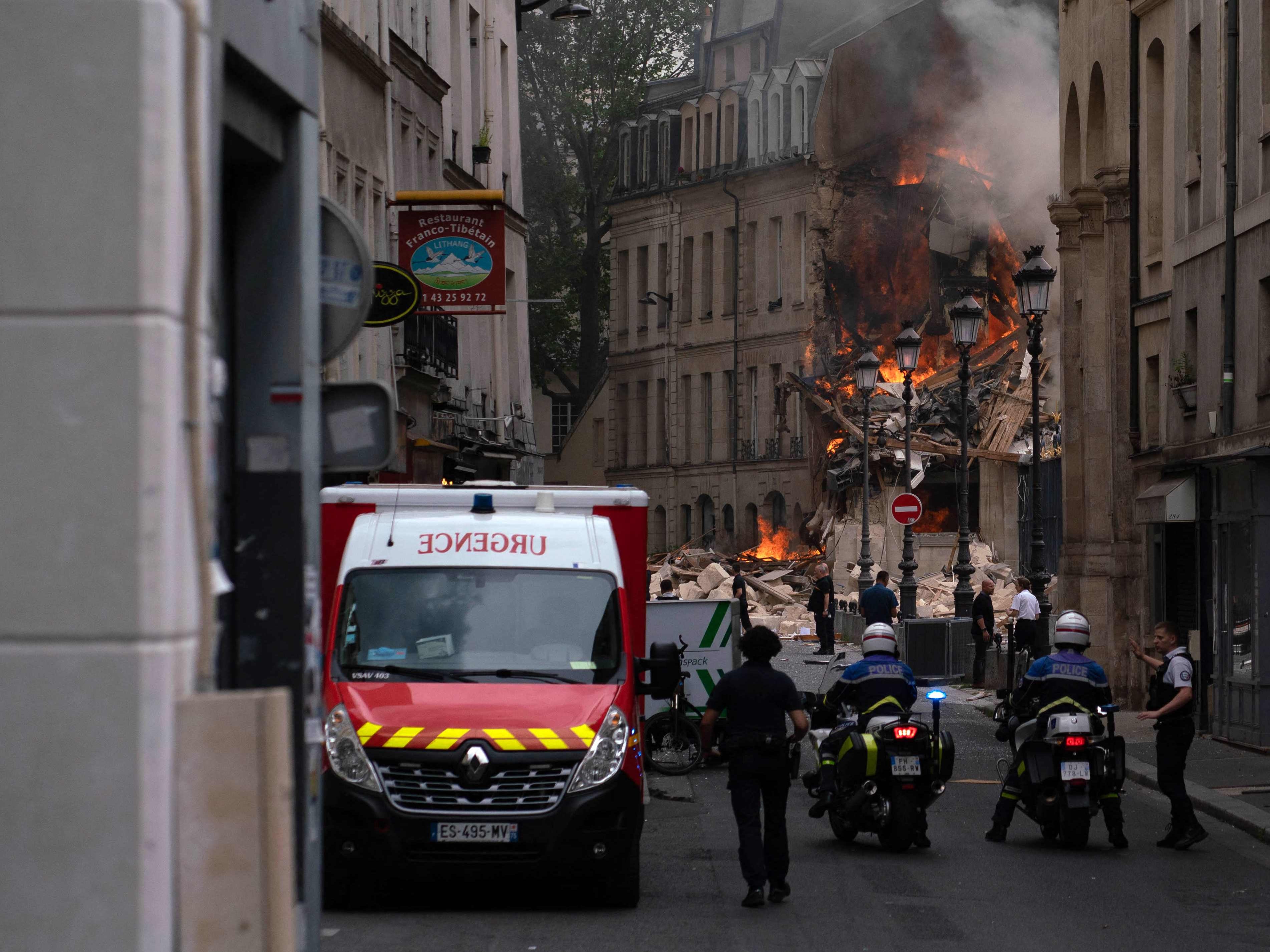 Smoke billows from rubbles of a building at Place Alphonse-Laveran in the 5th arrondissement of Paris