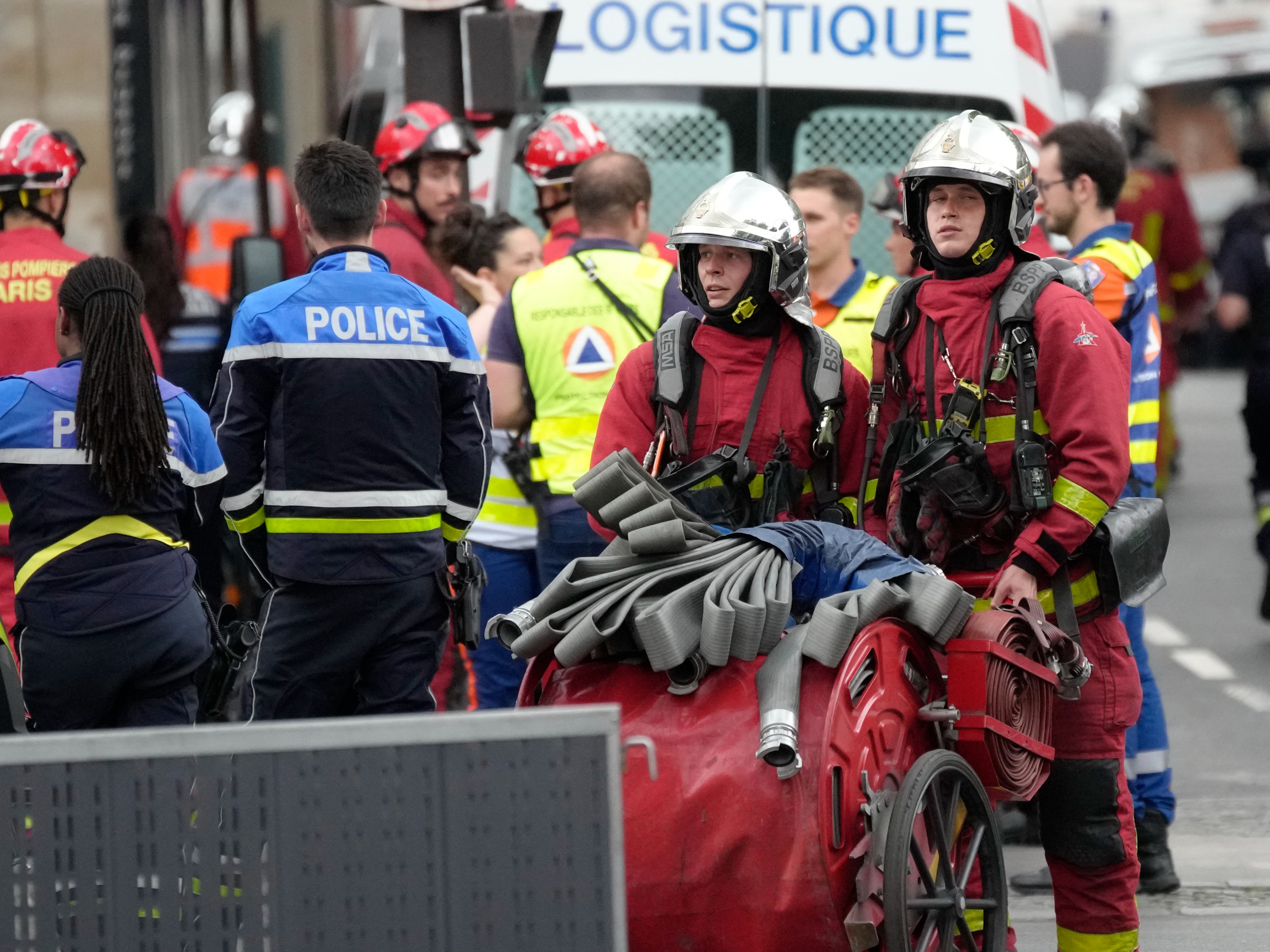 Police officers and rescue workers work at the scene of the blast