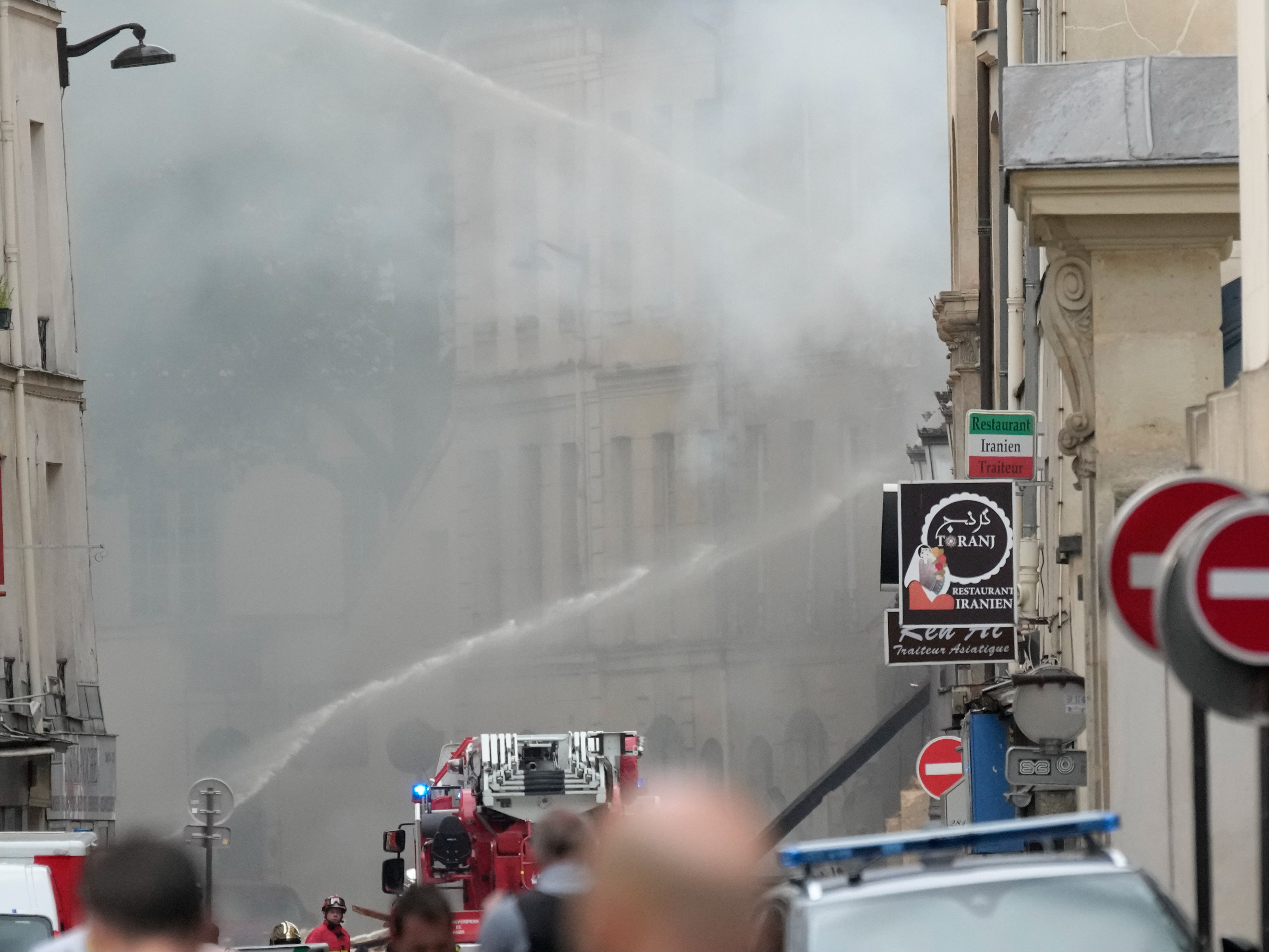 Firemen use a water canon to fight the blaze