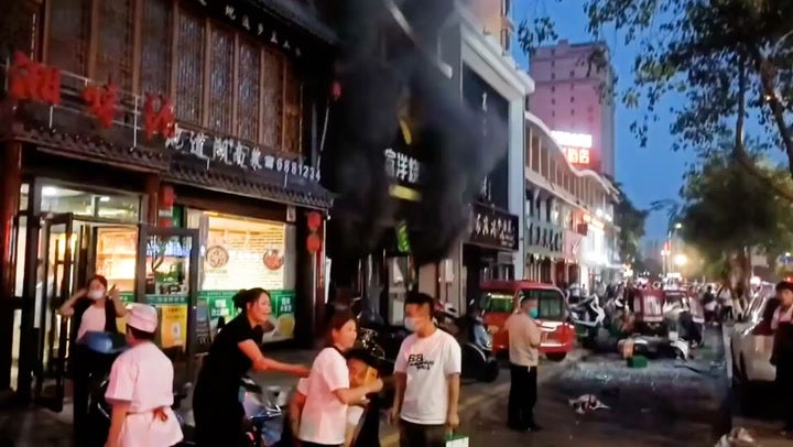 Plumes of smoke billow from Chinese barbecue restaurant as explosion kills 31