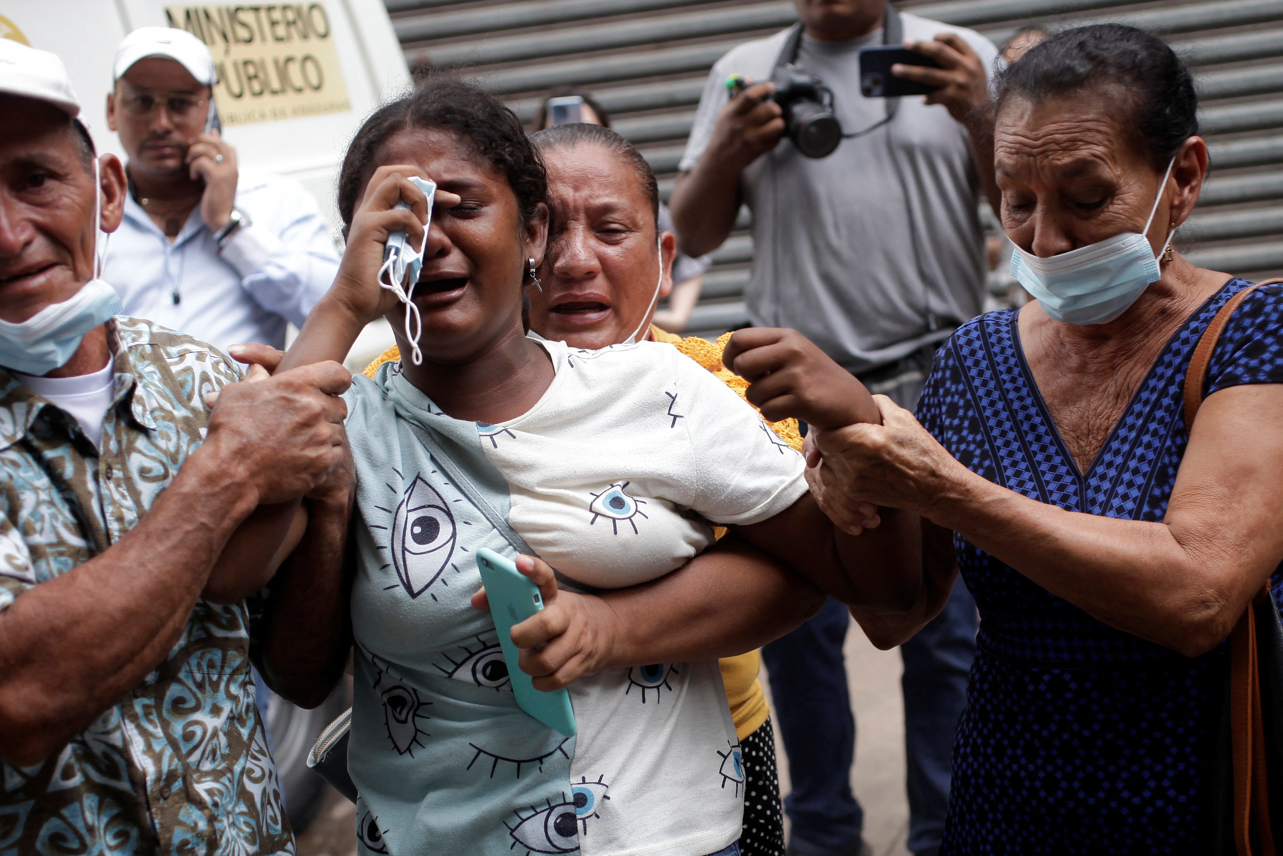 The relative of a victim of the deadly prison riot at the Centro Femenino de Adaptacion Social (CEFAS) women’s prison is comforted as she reacts outside a morgue in Tegucigalpa