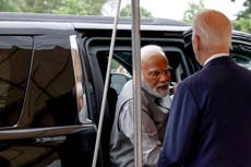 Trucks carrying protest banners drive through New York during Modi’s US visit