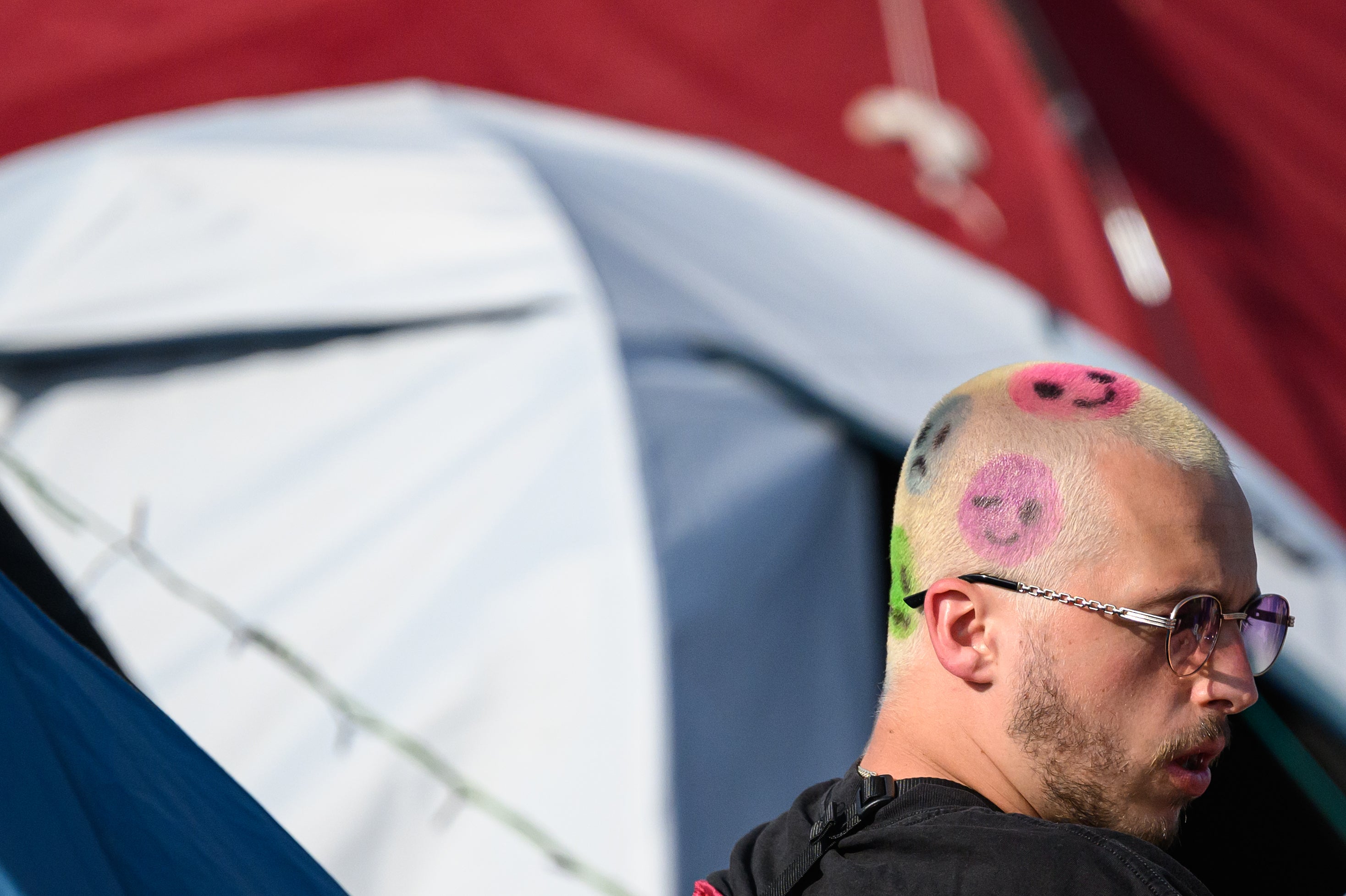 Festival-goers enjoy the morning sun as they sit outside their tents at the start of day two of Glastonbury Festival 2023