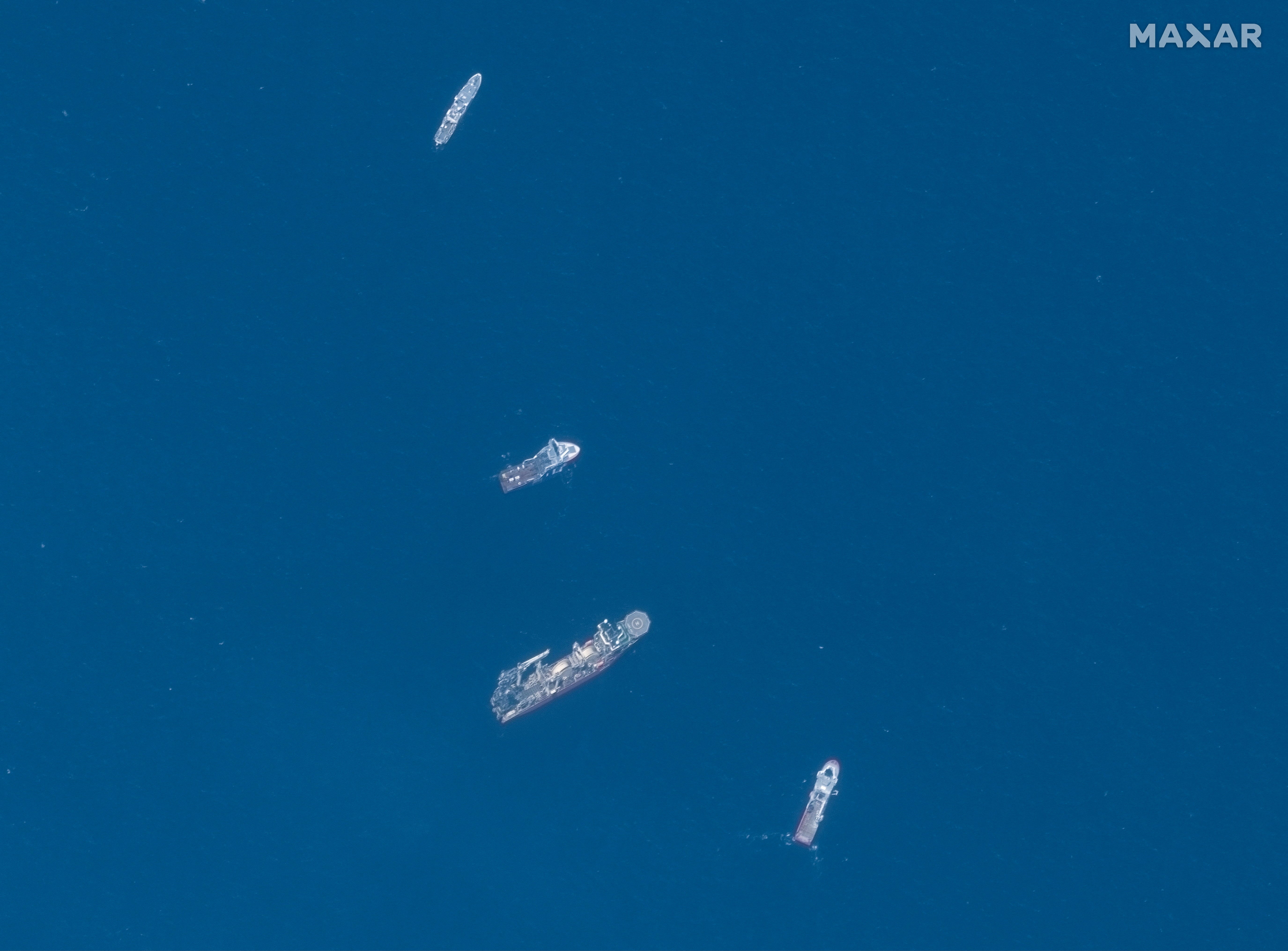 A satellite image shows ships taking part in the search and rescue operations associated with the missing Titan submersible near the wreck of the Titanic