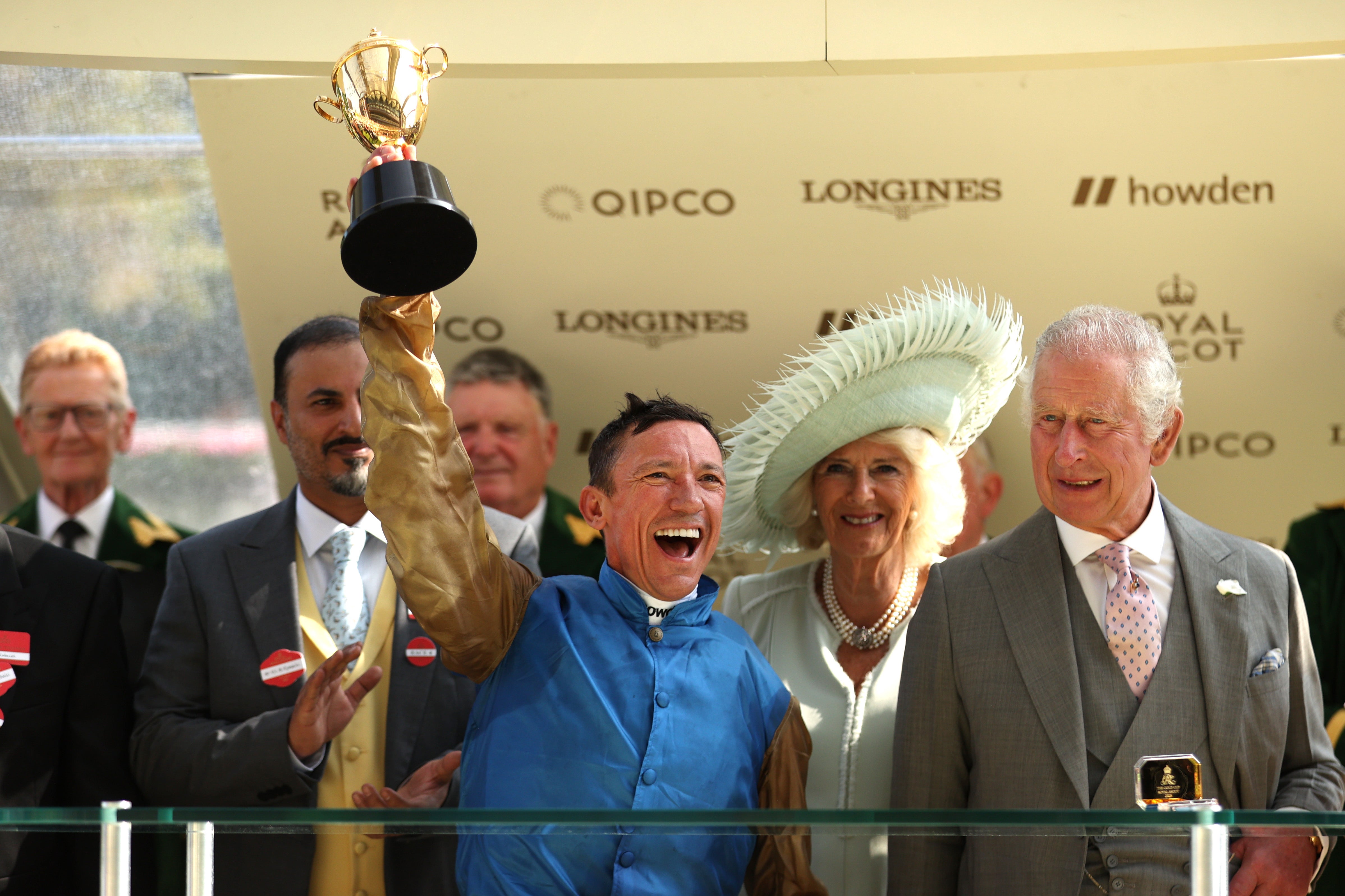 Frankie Dettori riding Courage Mon Ami lifts the Gold cup next to King Charles III and Queen Camilla during day three of Royal Ascot 2023