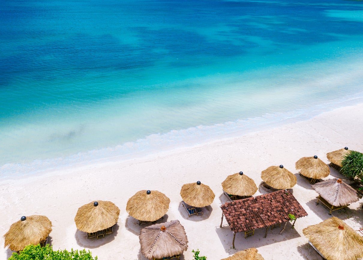 Bali’s white sands sparkle under clear blue skies during dry season