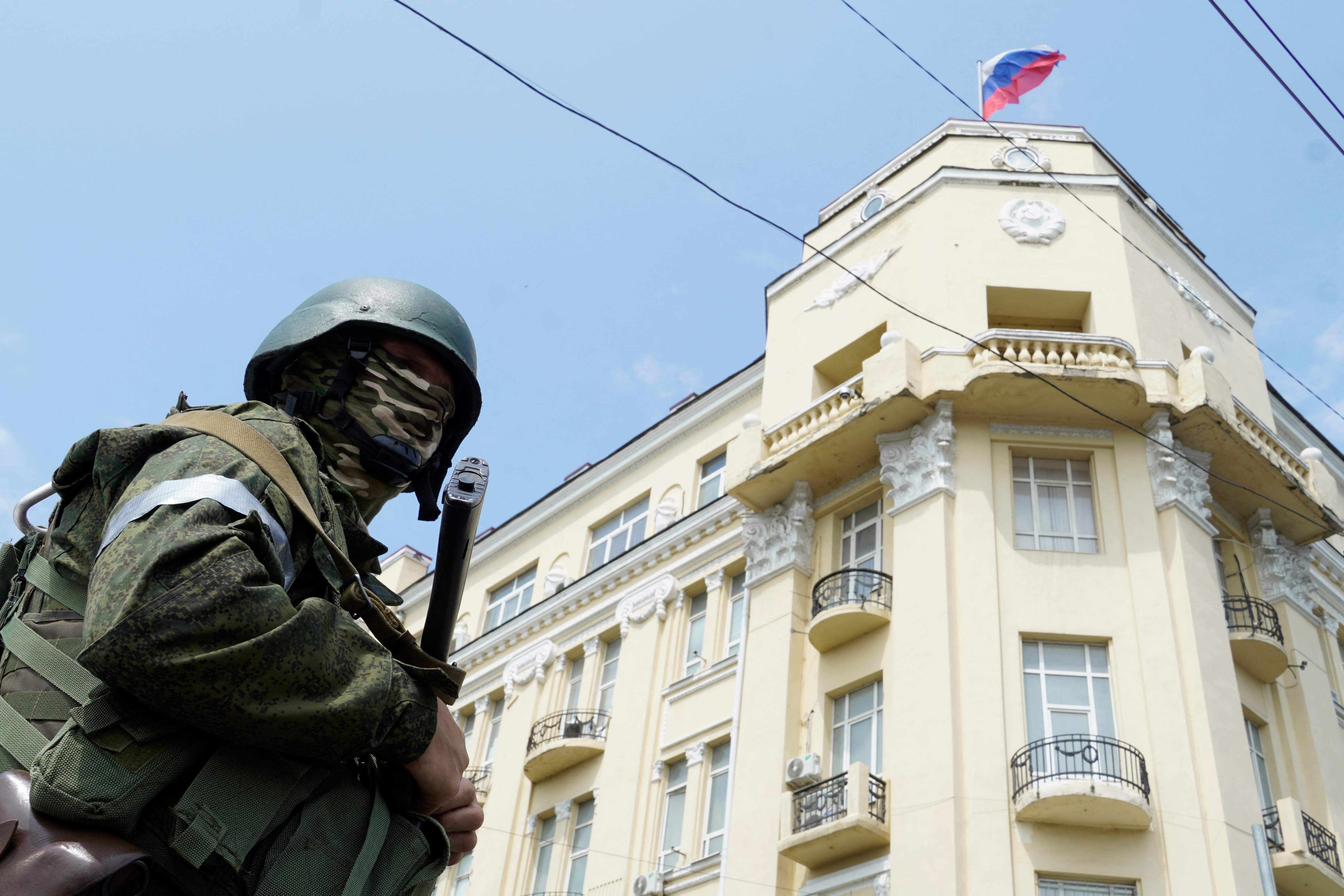 A member of Wagner Group stands guard in a street in the city of Rostov-on-Don
