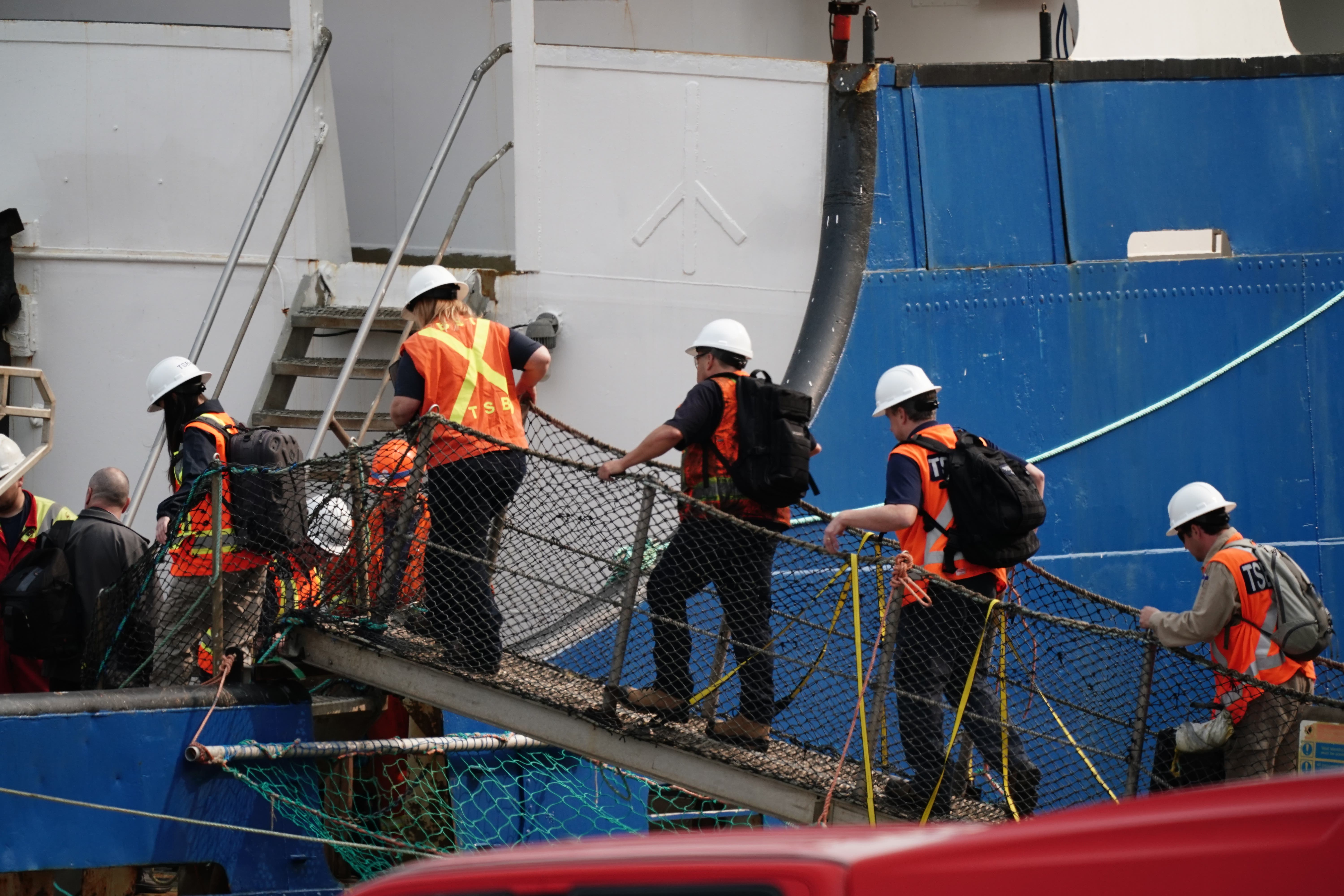 Officials from the Transportation Safety Board of Canada board the Polar Prince (Jordan Pettitt/PA)