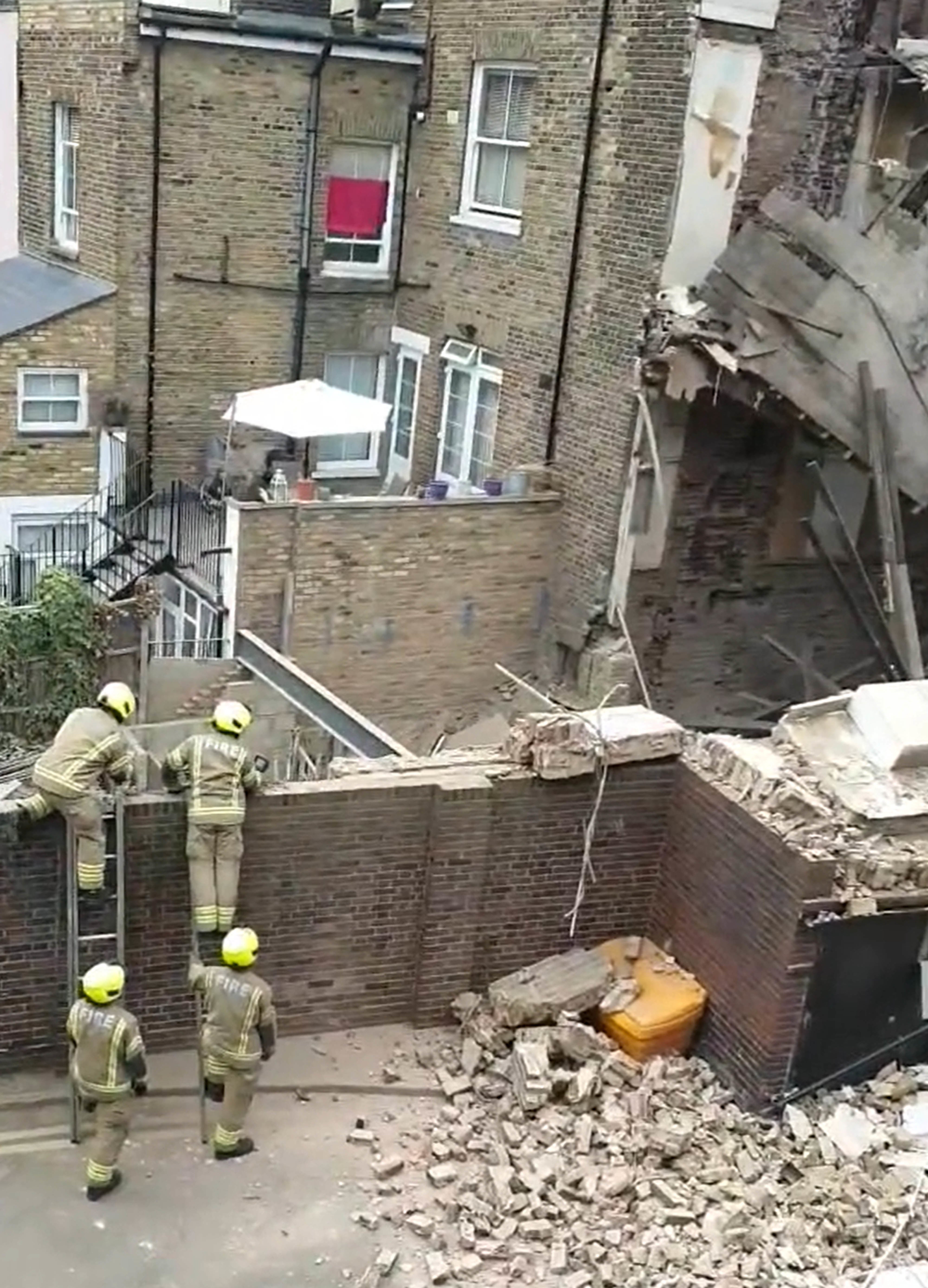 Firefigters at the scene of the house collapse in Hackney