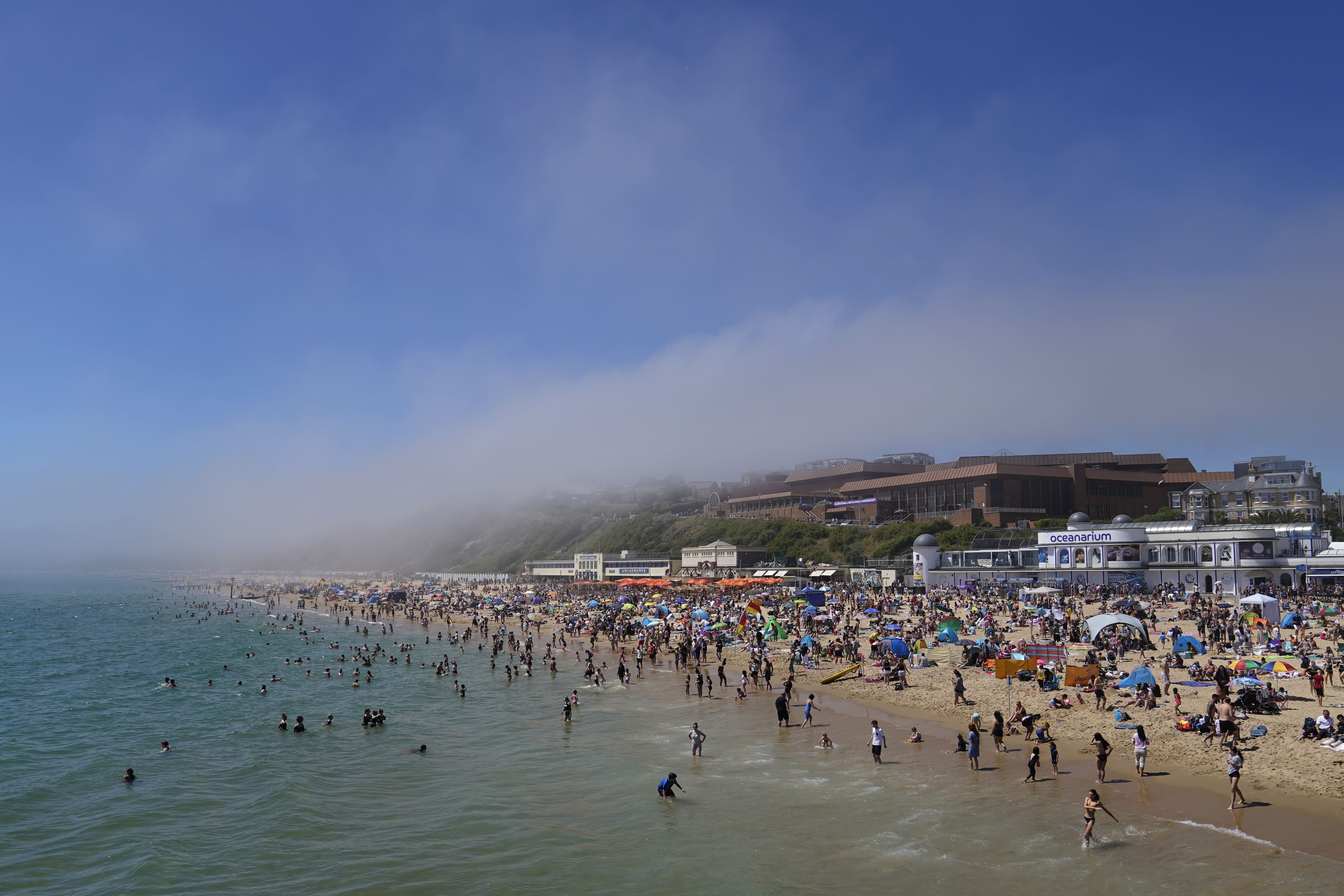 People enjoy the warm weather on Bournemouth Beach (Andrew Matthews/PA)