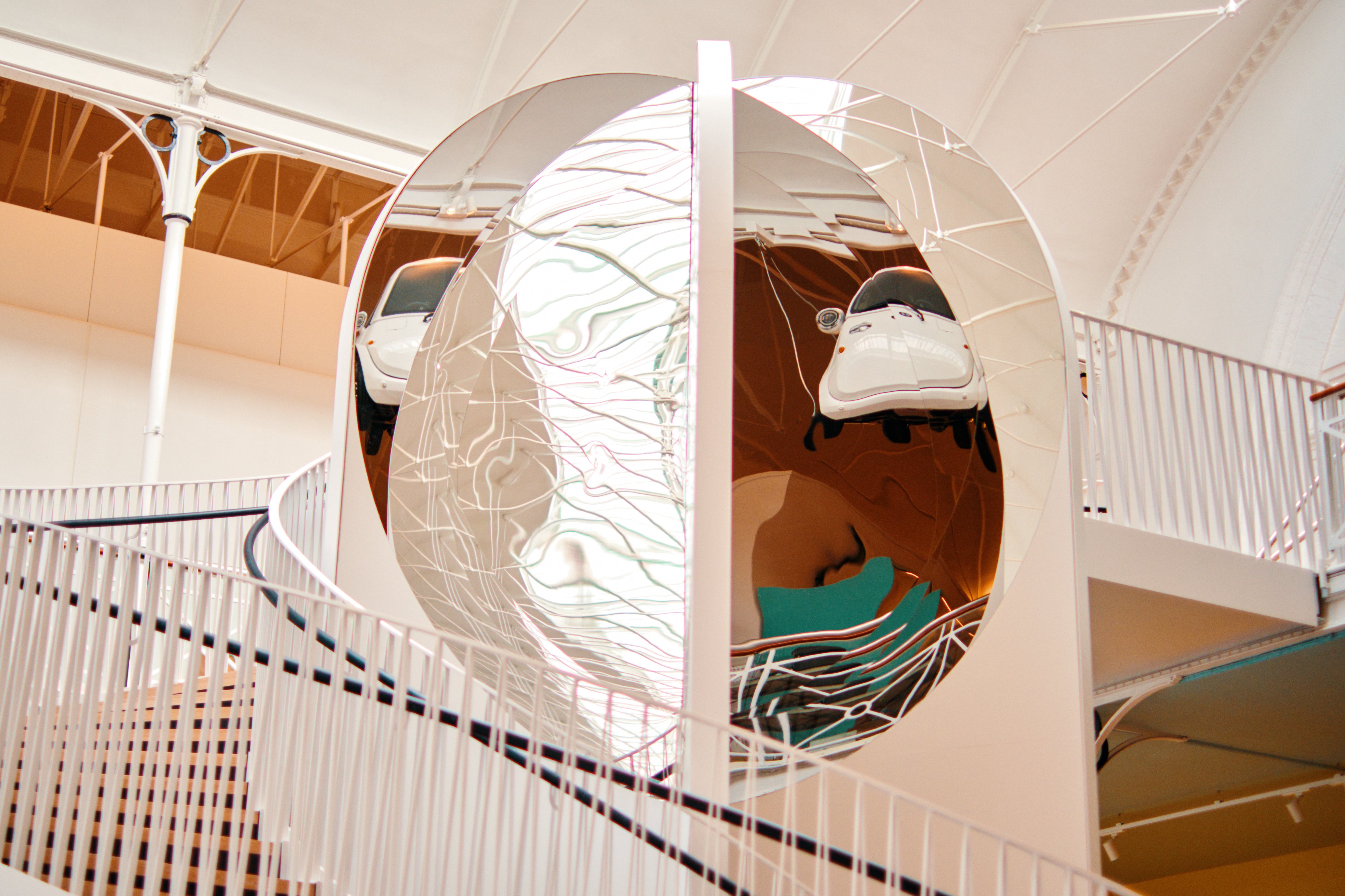 Kaleidoscopic staircase reflecting the ‘Microlino Electric Vehicle’, 2019, at the new Young V&A museum