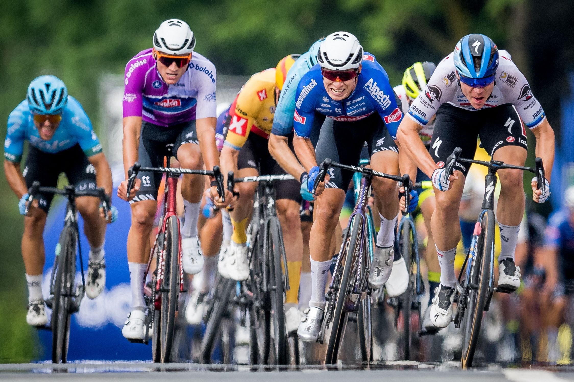 Alpecin-Deceuninck’s Dutch rider Mathieu van der Poel, Alpecin-Deceuninck’s Belgian rider Jasper Philipsen, and Soudal Quick-Step’s Dutch rider Fabio Jakobsen sprint to the finish line