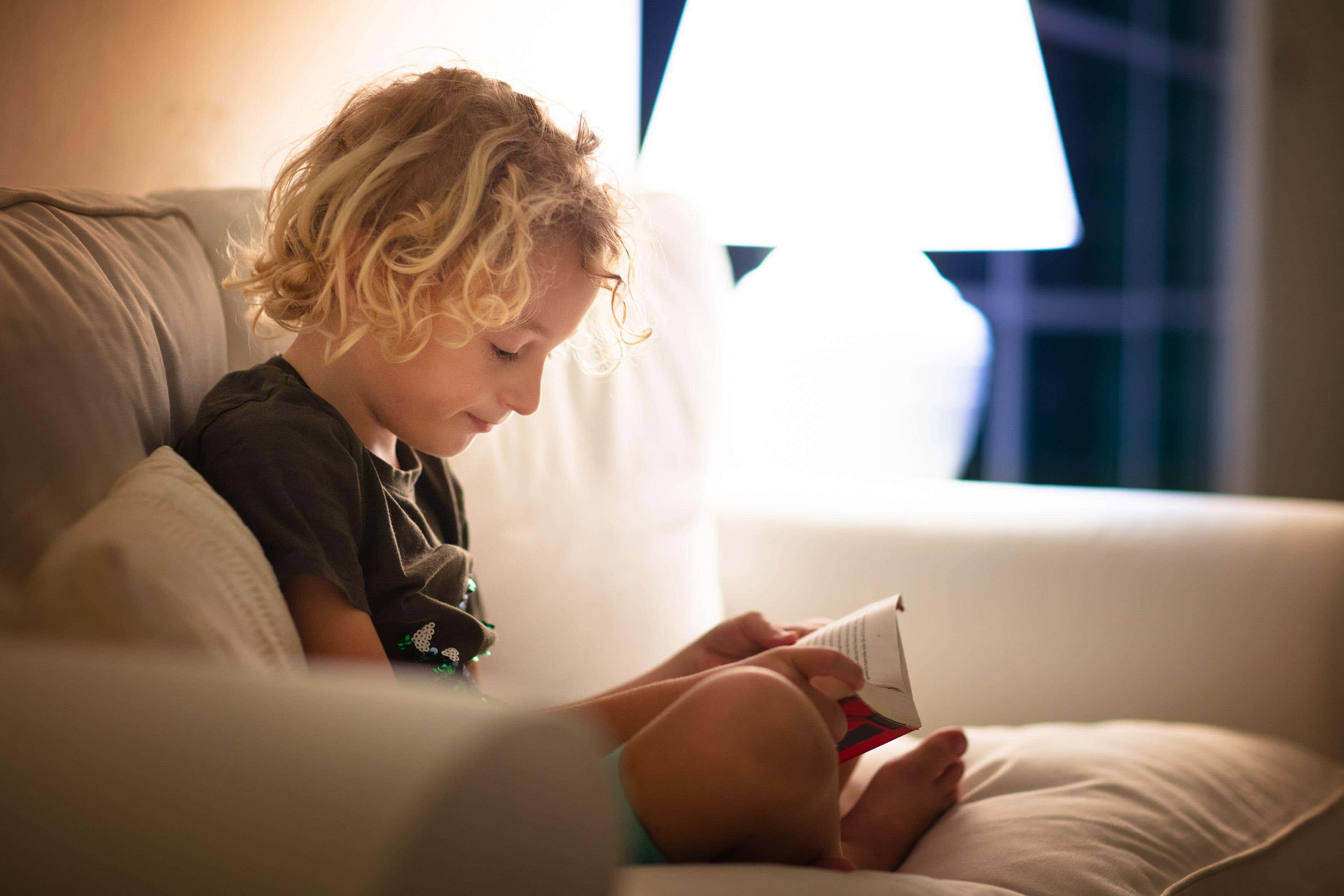 Reading for pleasure early in childhood has been linked to better cognitive performance and mental wellbeing in adolescence (Alamy/PA)