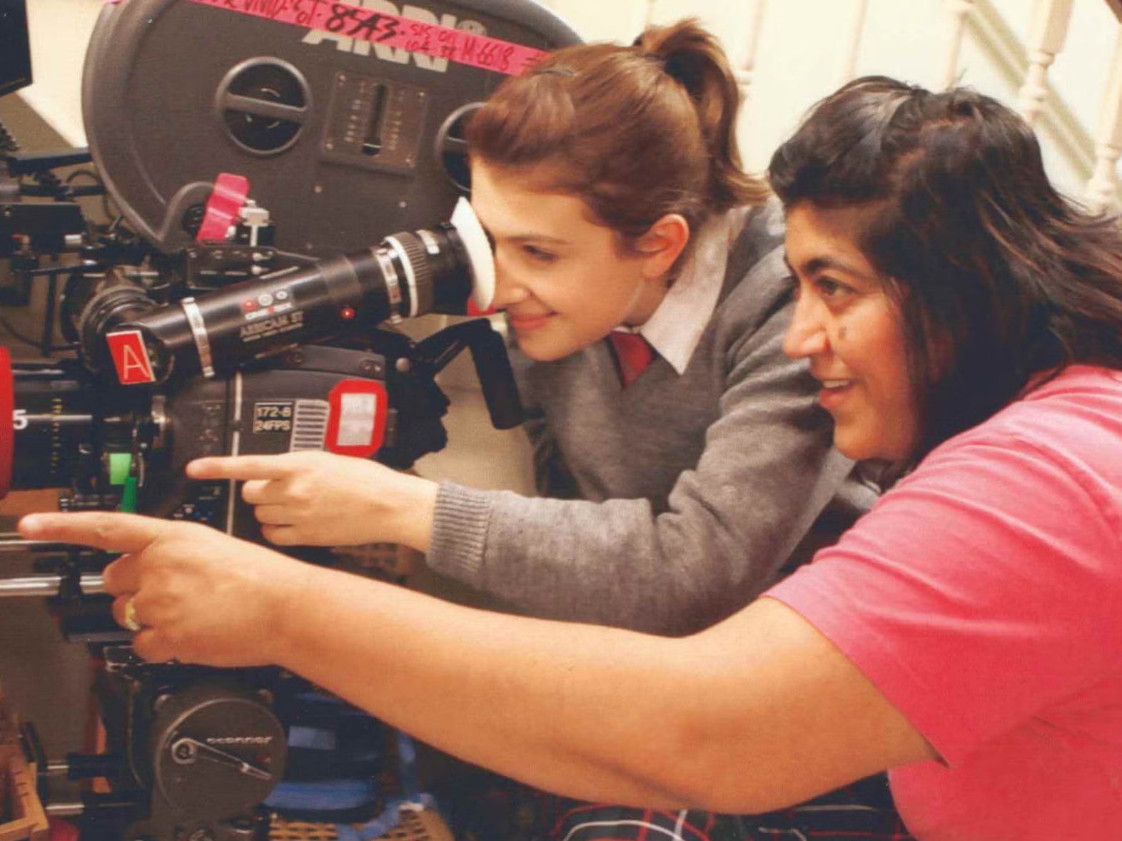 Chadha teaching Groome to use a camera