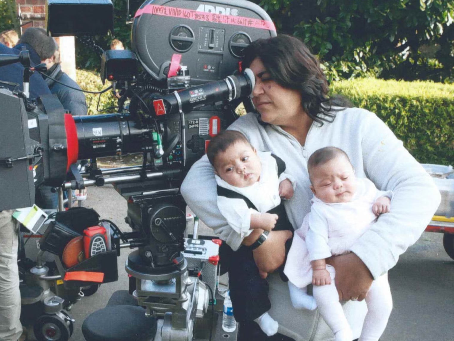 Chadha directing with her twins in hand