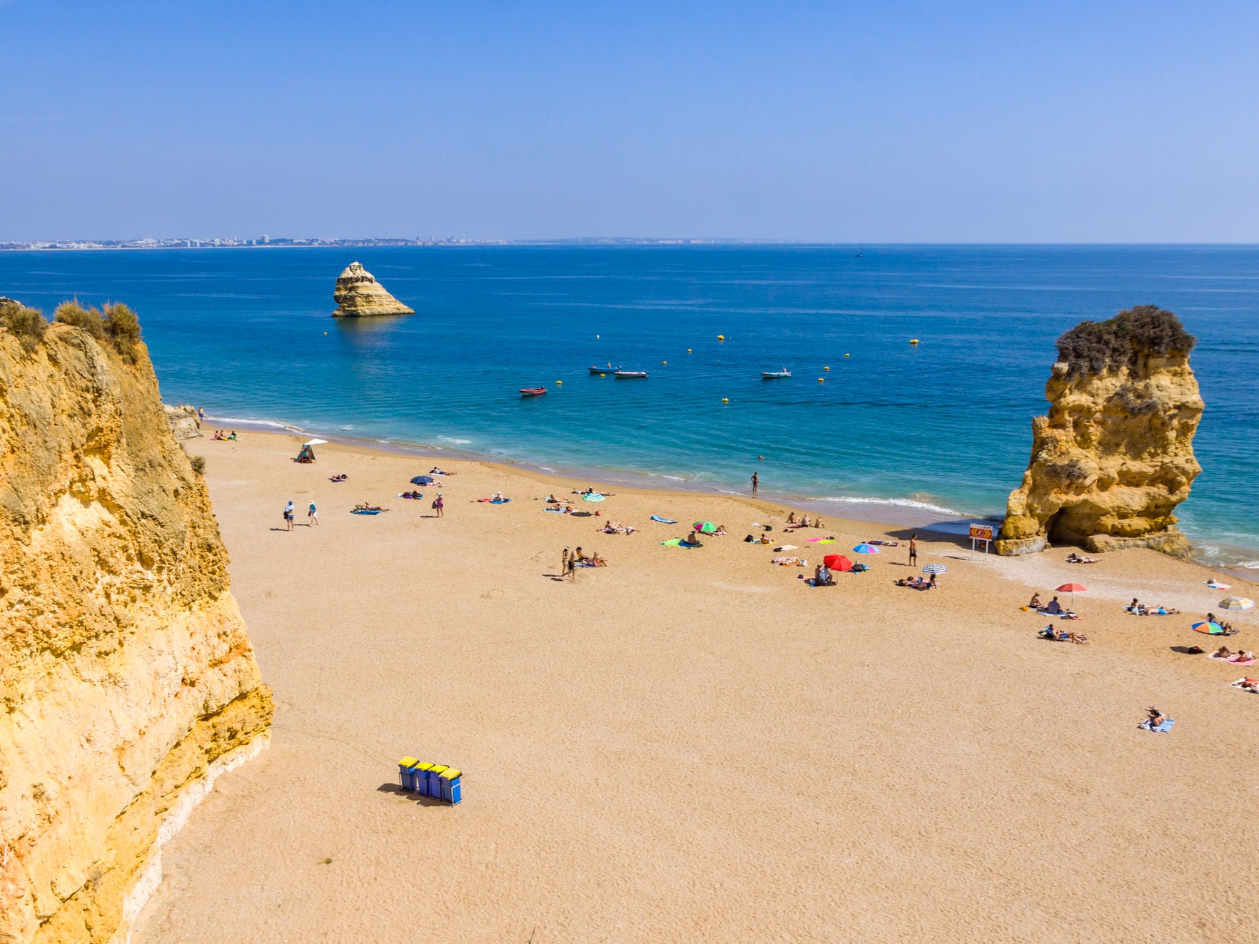 Climb down some steps onto this long, sandy beach with turquiose waters