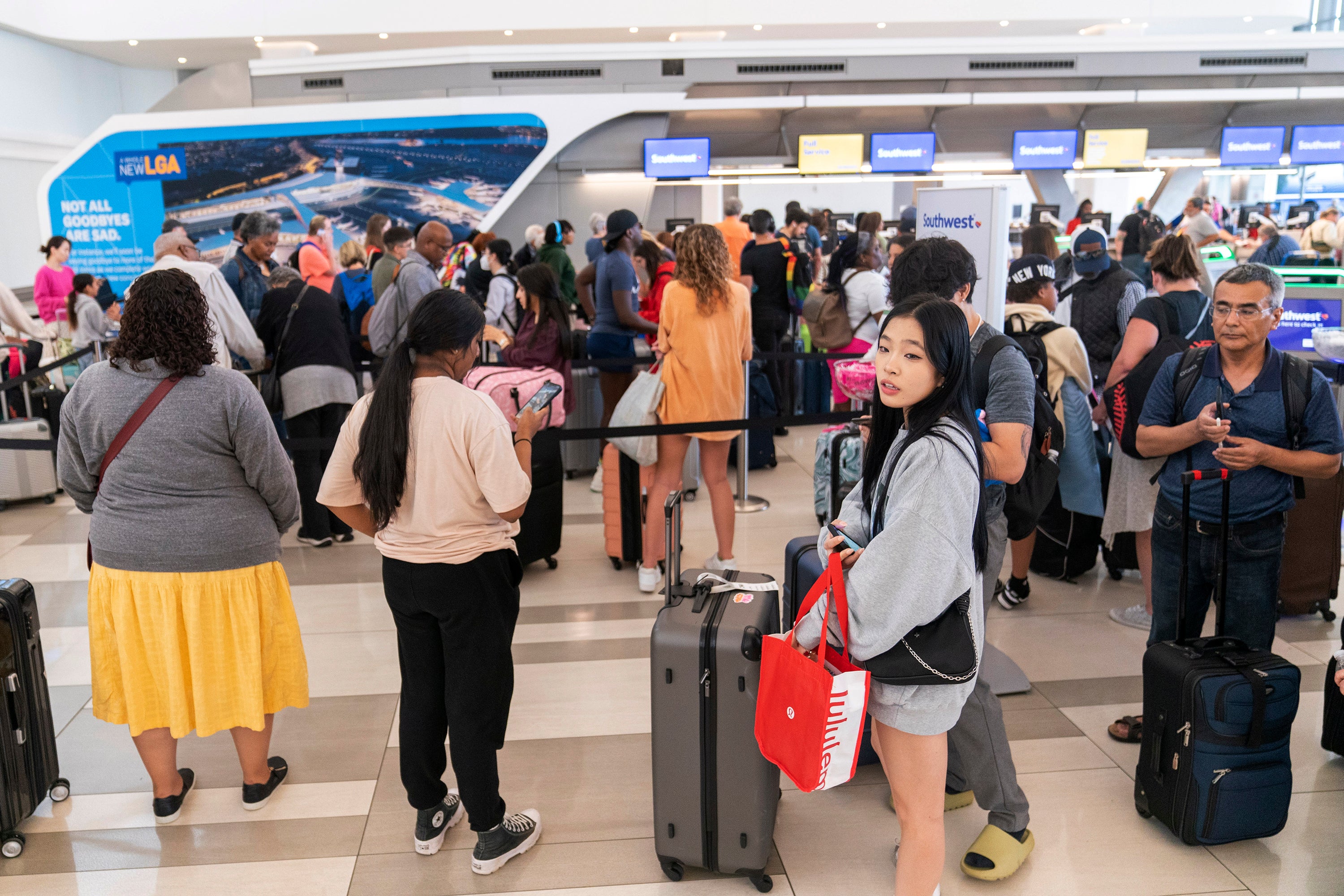 Long lines surround a Southwest ticket counter at LaGuardia Airport