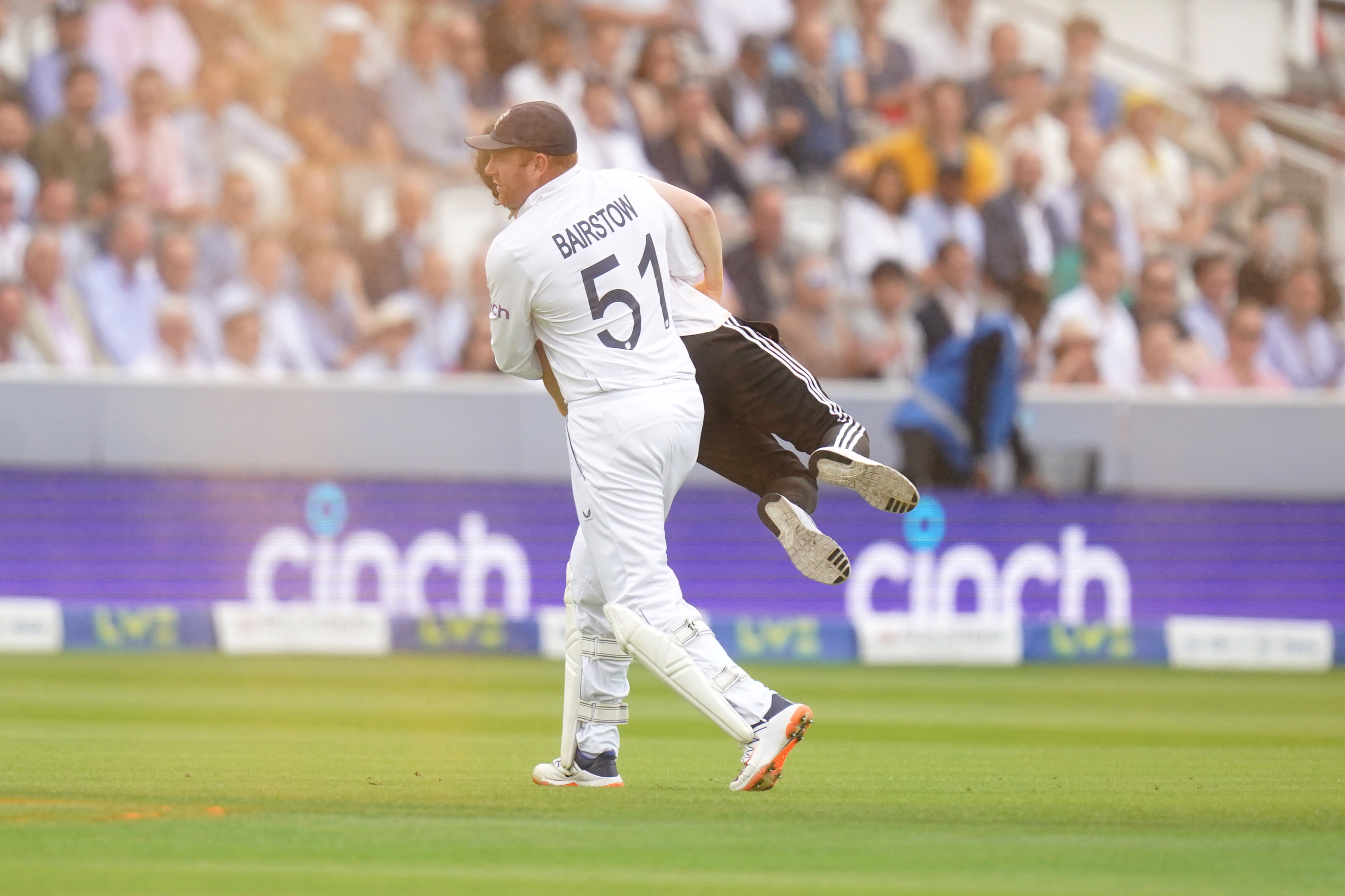 Jonny Bairstow carries a Just Stop Oil protester off the pitch (Adam Davy/PA)