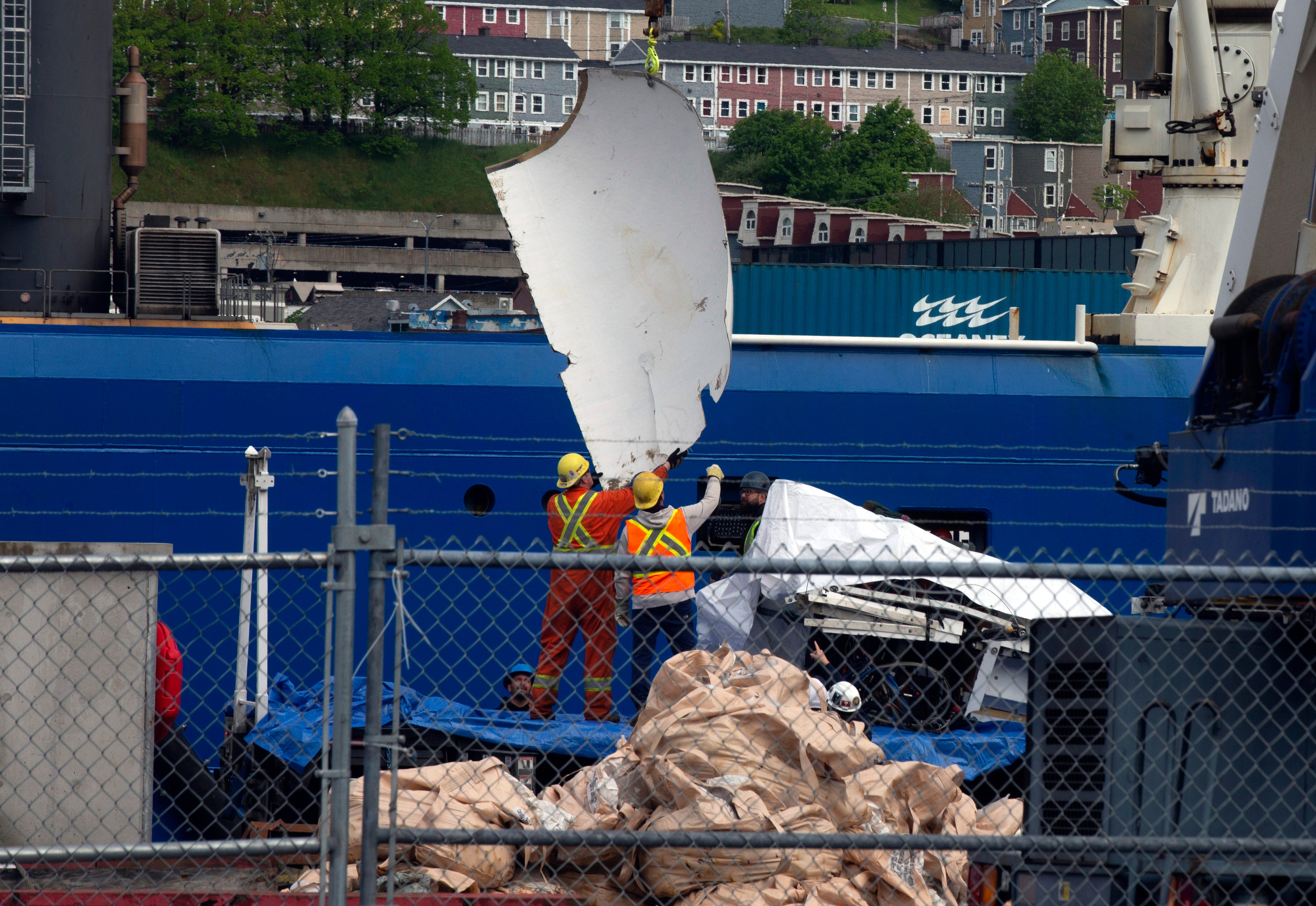 Debris from the Titan submersible, recovered from the ocean floor near the wreck of the Titanic, is unloaded from the shore