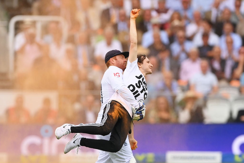 Jonny Bairstow carries a Just Stop Oil protester off the pitch