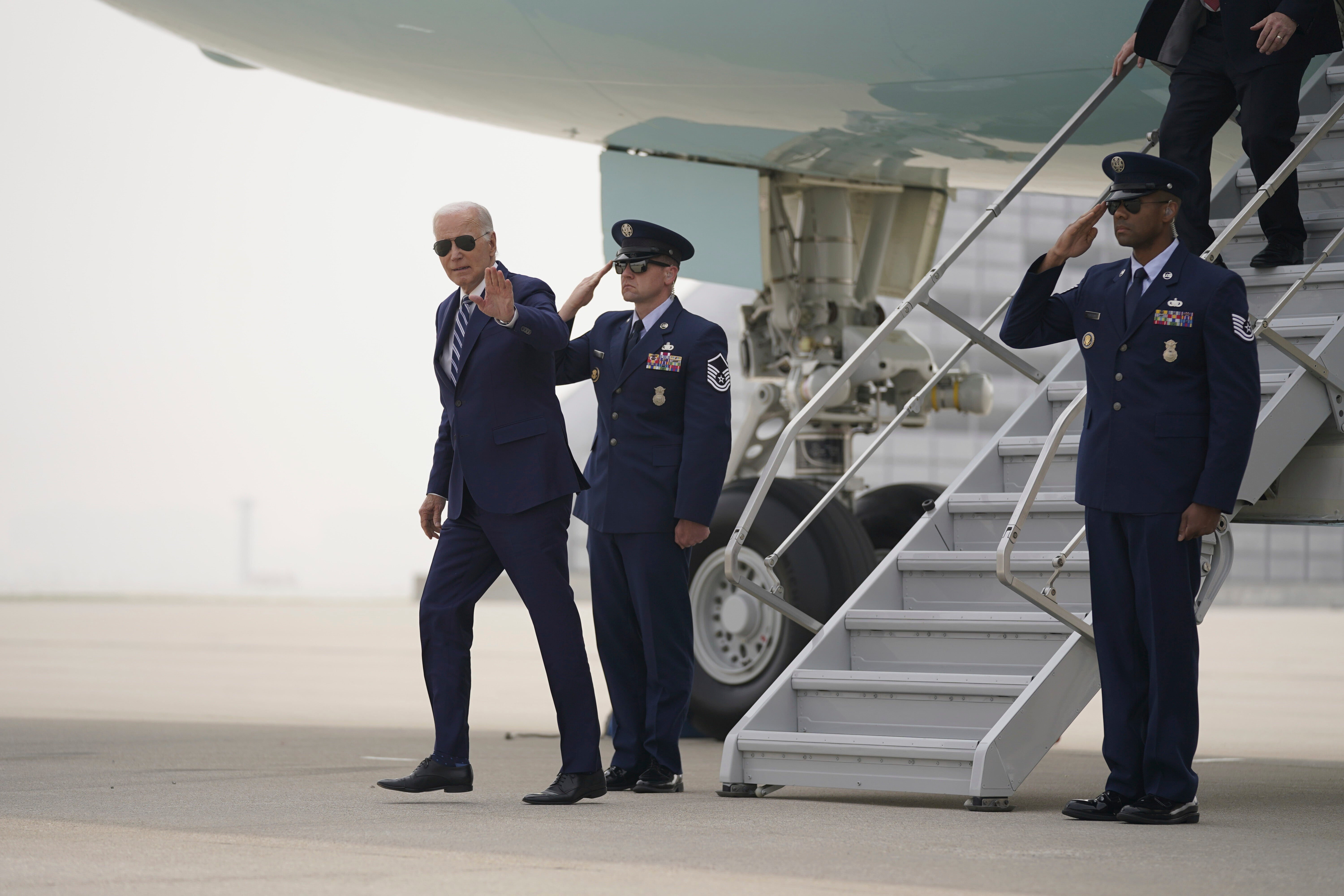 President Joe Biden arrives at O’Hare International Airport where smoke from Canadian wildfires has blanketed the city