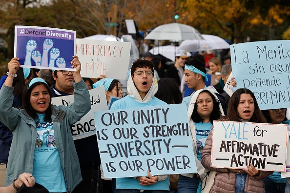 Protestors in favor of affirmative action protest in front of the Supreme Court during oral arguments