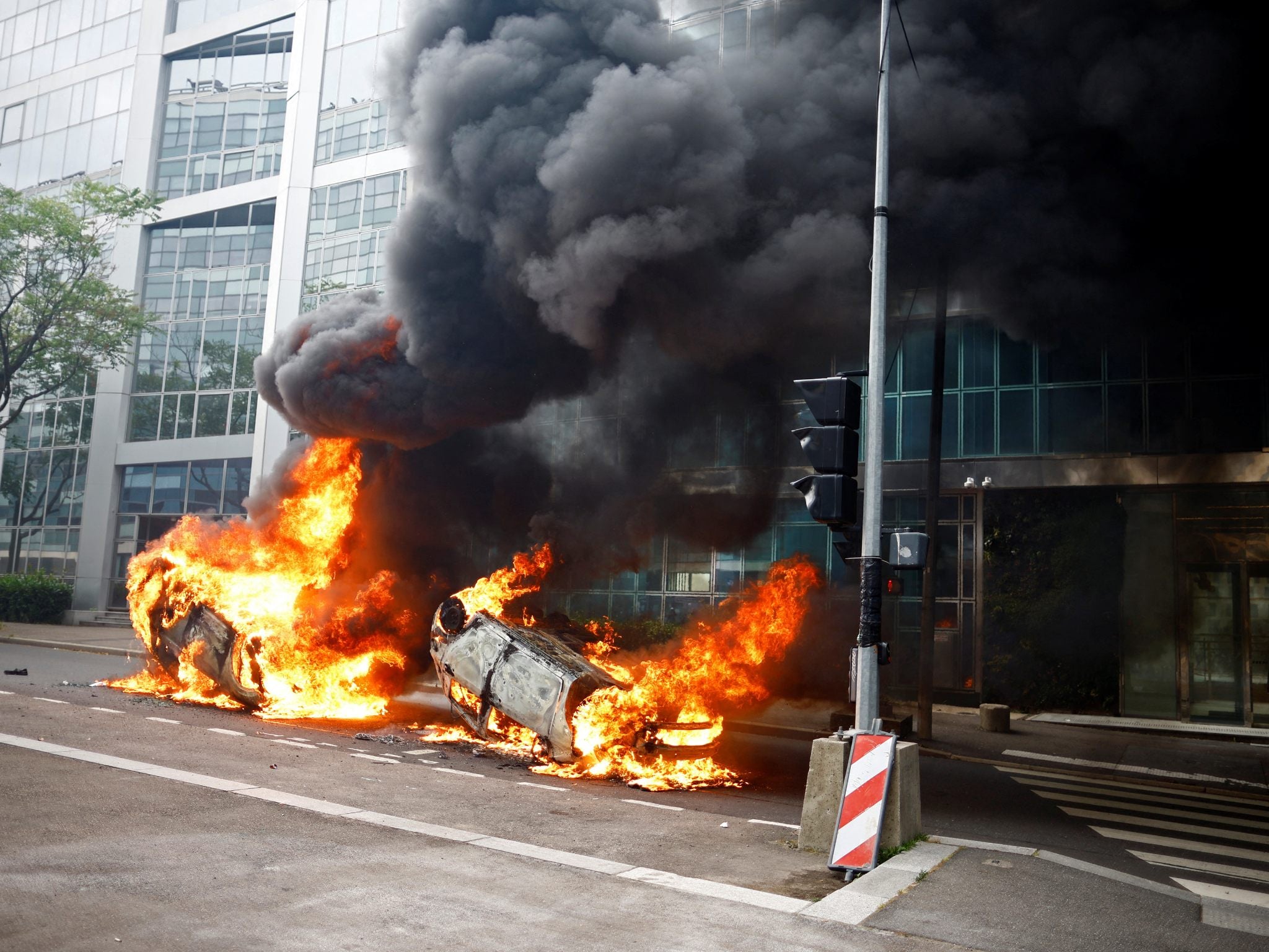 Burning vehicles on a street in Nanterre amid clashes between protesters and police