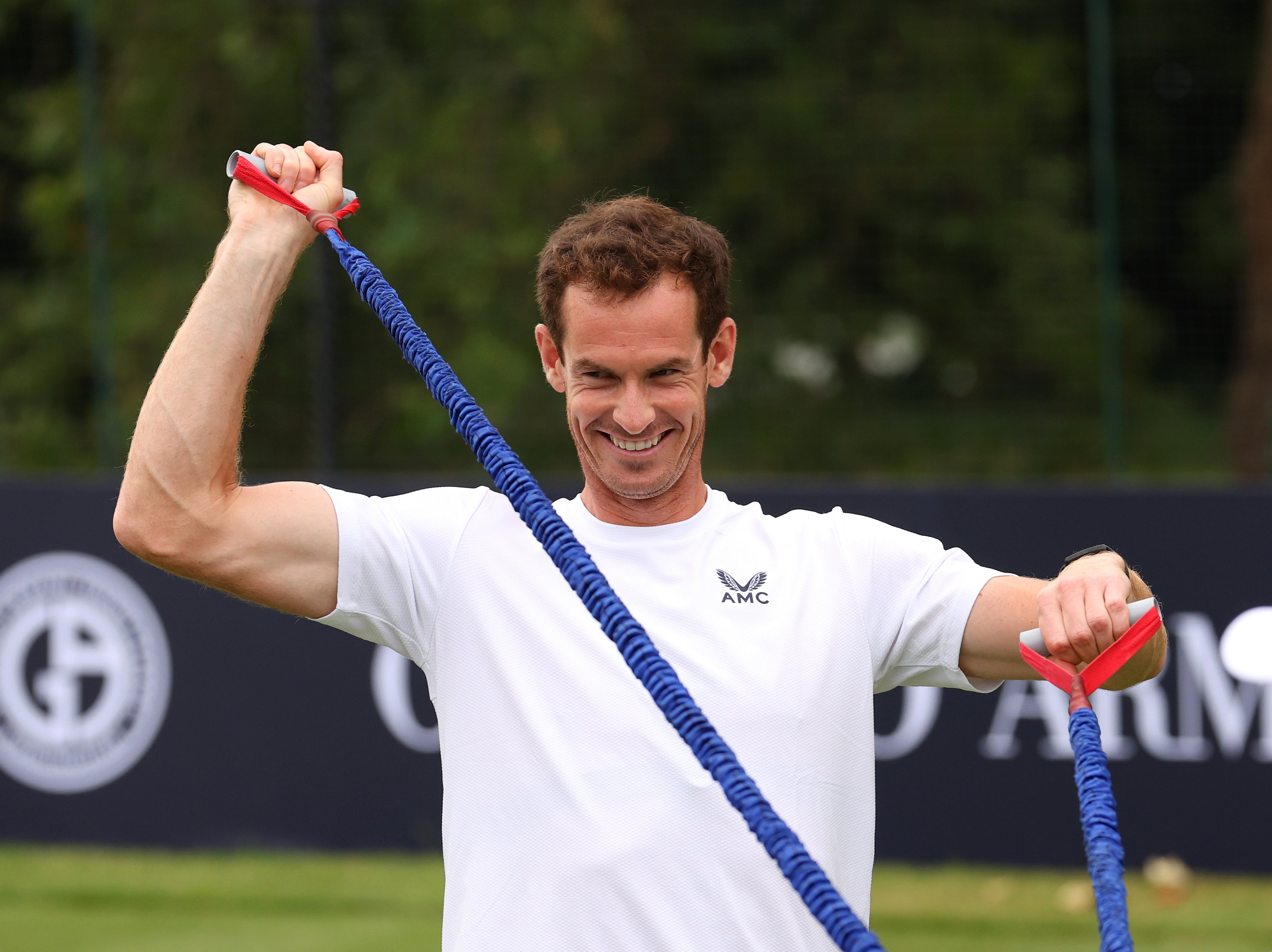 Andy Murray stretches before the Exhibition Match against Holger Rune