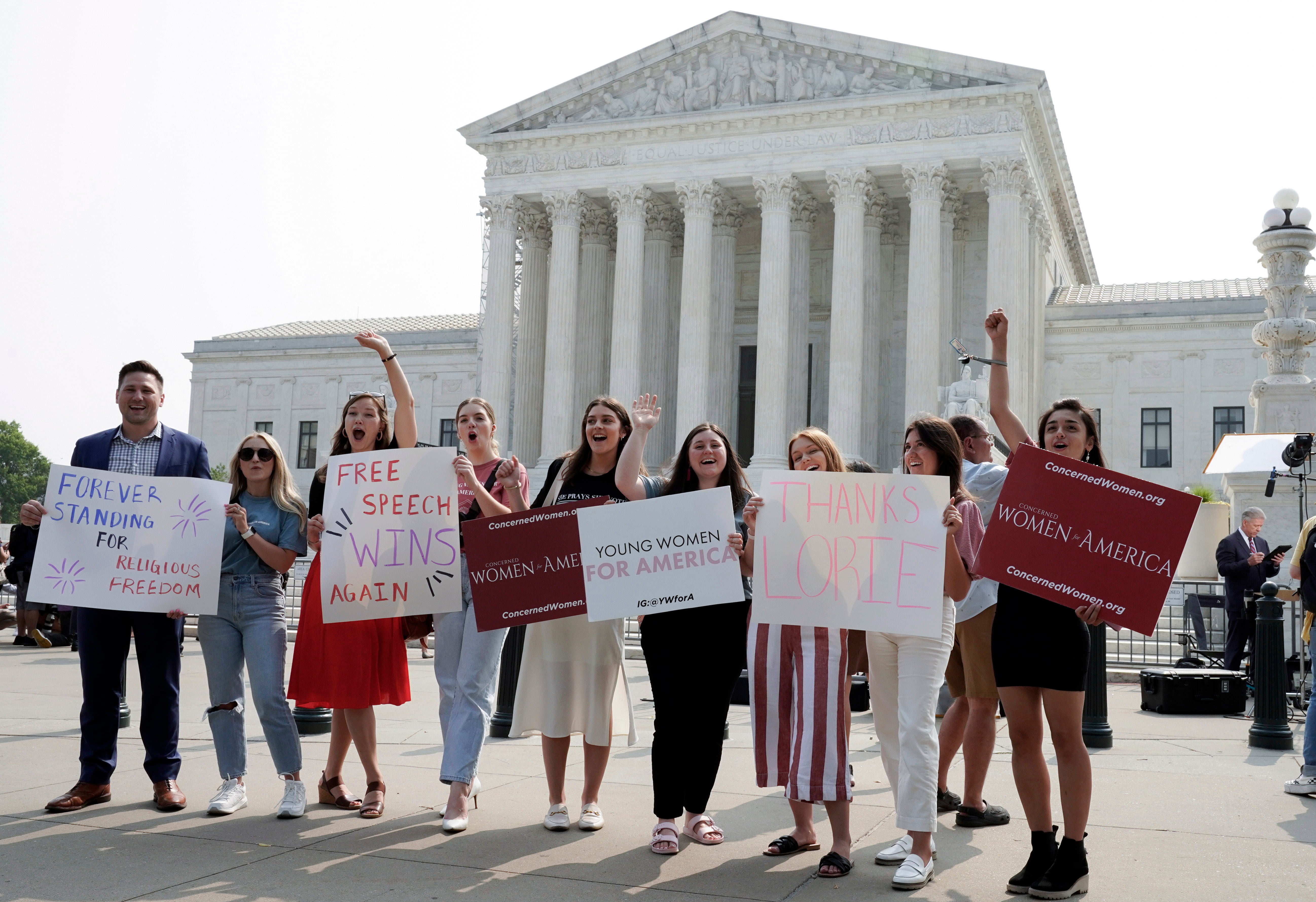 Demonstrators who supported Lorie Smith’s case celebrate the US Supreme Court ruling in Washington DC on 30 June