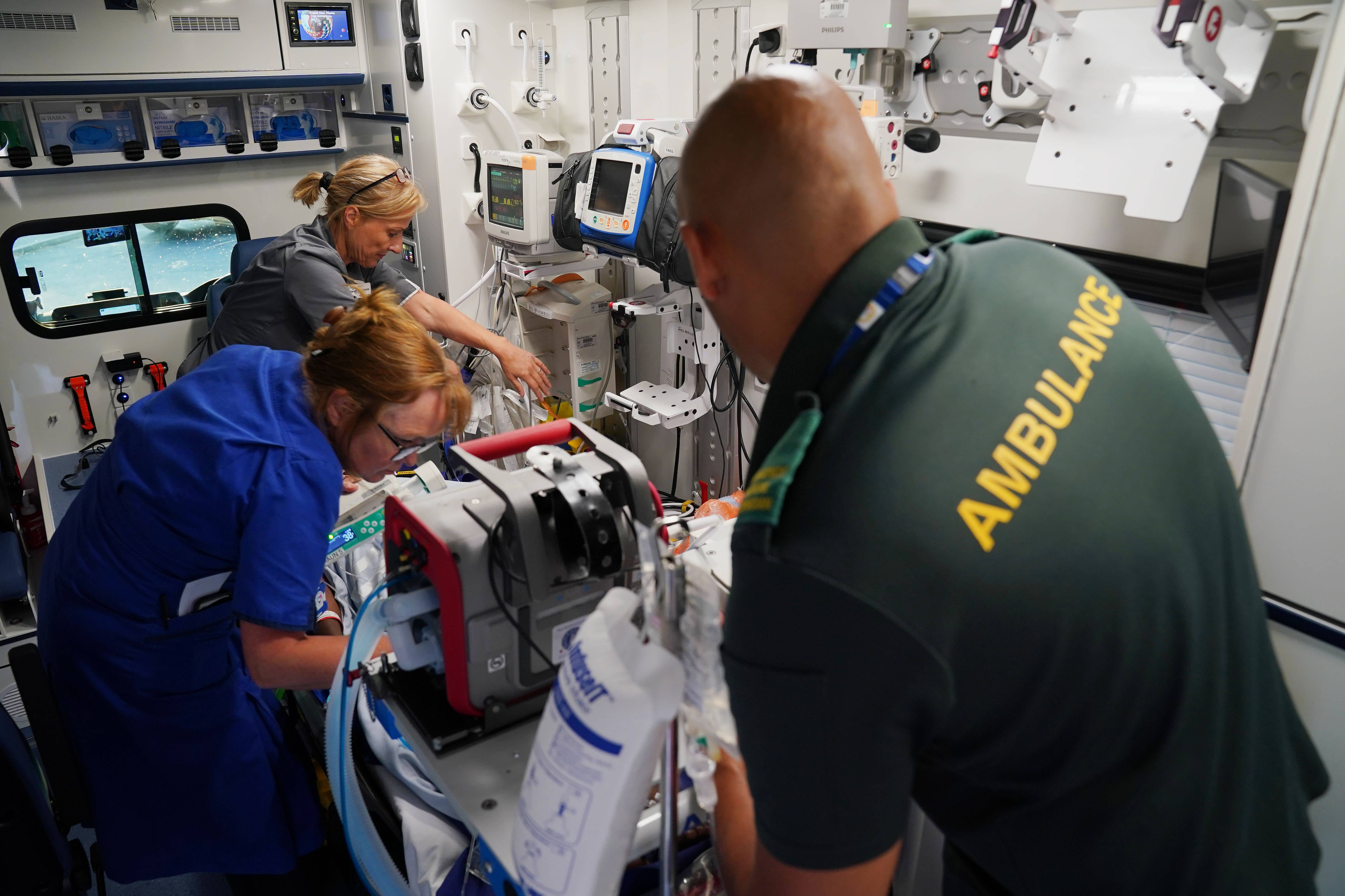 Advanced Nurse Practitioner Sarah Hardwick (top left) alongside Senior Staff Nurse Jayne Farrance (bottom left) and Ambulance Technician Blair McMurray (right) leave East Surrey Hospital (Jonathan Brady/PA)